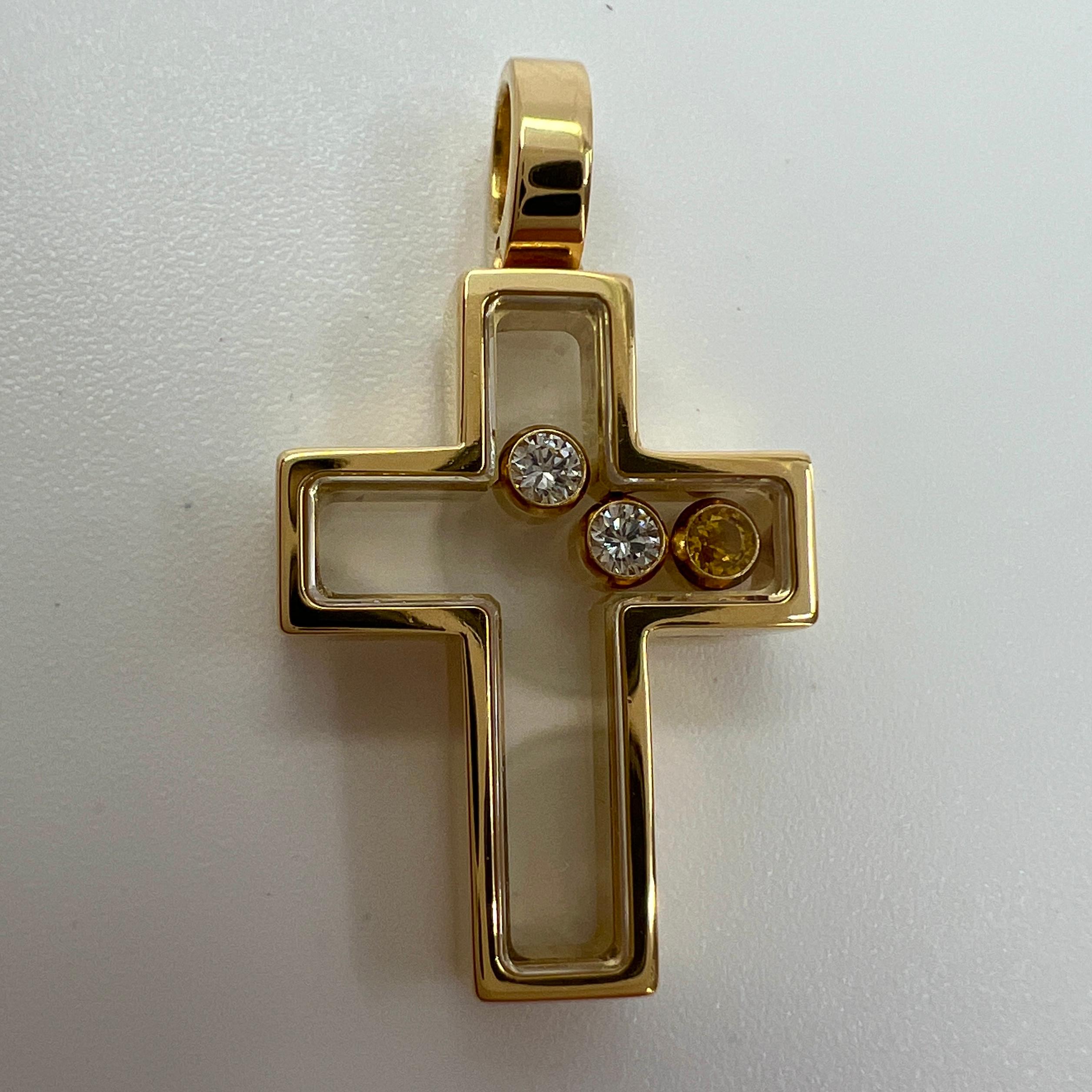 A Rare Chopard Happy Diamonds 18k Yellow Gold Cross Pendant.

Inspired by drops of water, Chopard's Happy Diamonds Icons collection features diamonds that are free to swirl gracefully behind sapphire crystal glass, enhancing their sparkle with every