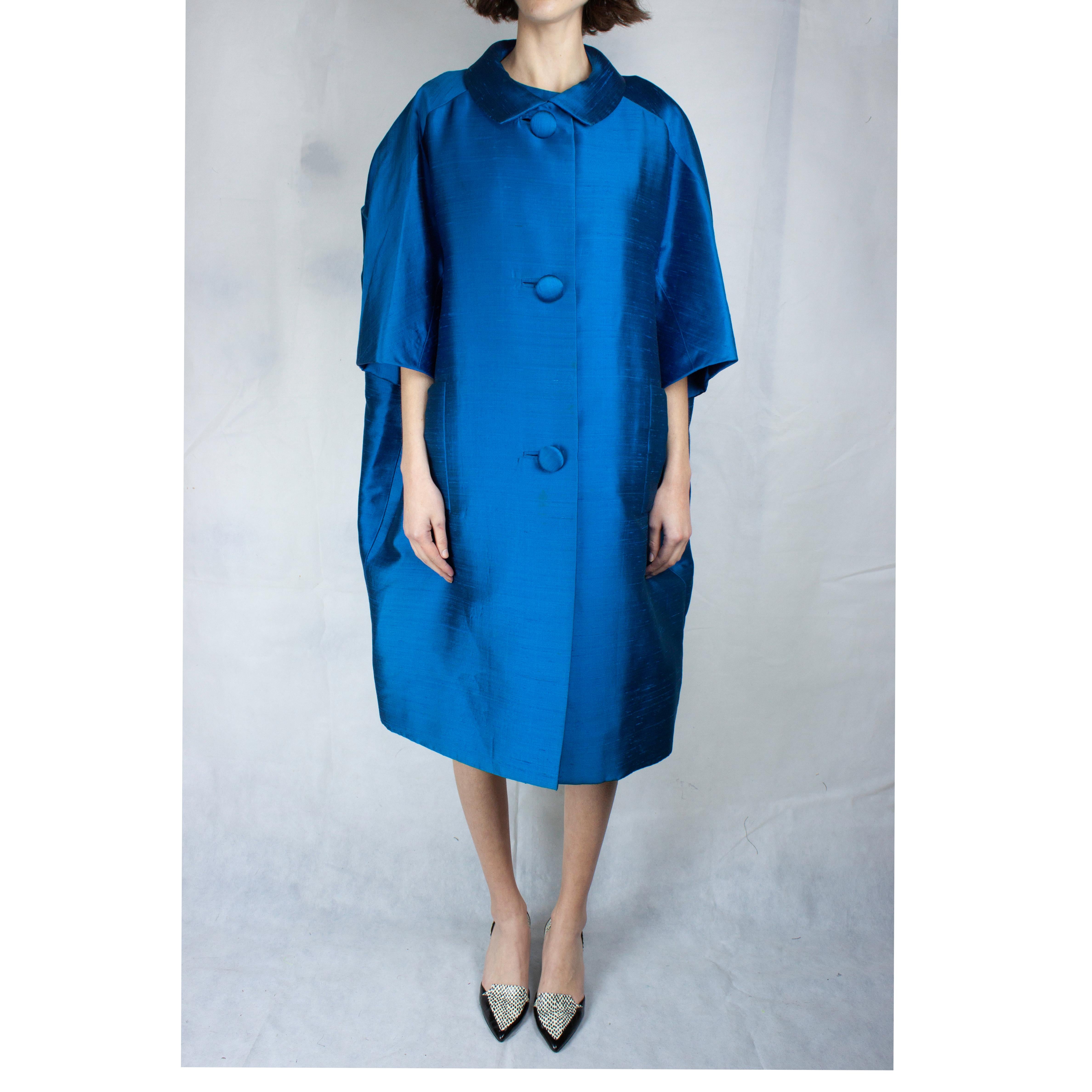 
This complexity tailored Christian Dior ensemble is constructed with a lustrous turquoise raw silk dupion material. The coat features a round silhouette tailoring, round turndown collar and two vertical pockets on the hip. The piece fasten with a