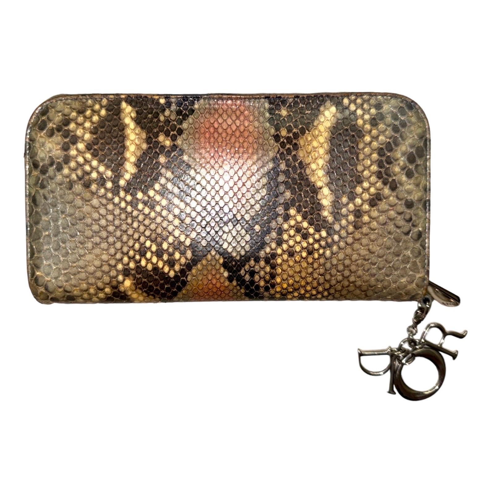 A wonderful Lady Dior exotic skin wallet by Christian Dior

Details:

Finest python skin
Detachable 'D.I.O.R.' charm
Blue leather lining
3 compartments
12 card slots
2 patch pockets
1 zipped pocket
Made in Italy

This Lady Dior Voyageur wallet is