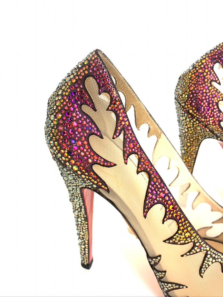 Christian Louboutin Marlena Lili Marlene Pumps. Made from nude mesh, it features multicolor crystals in a flame design that flow through to the trims and heels of the pumps. The interiors are leather lined. This piece is a collector's item.