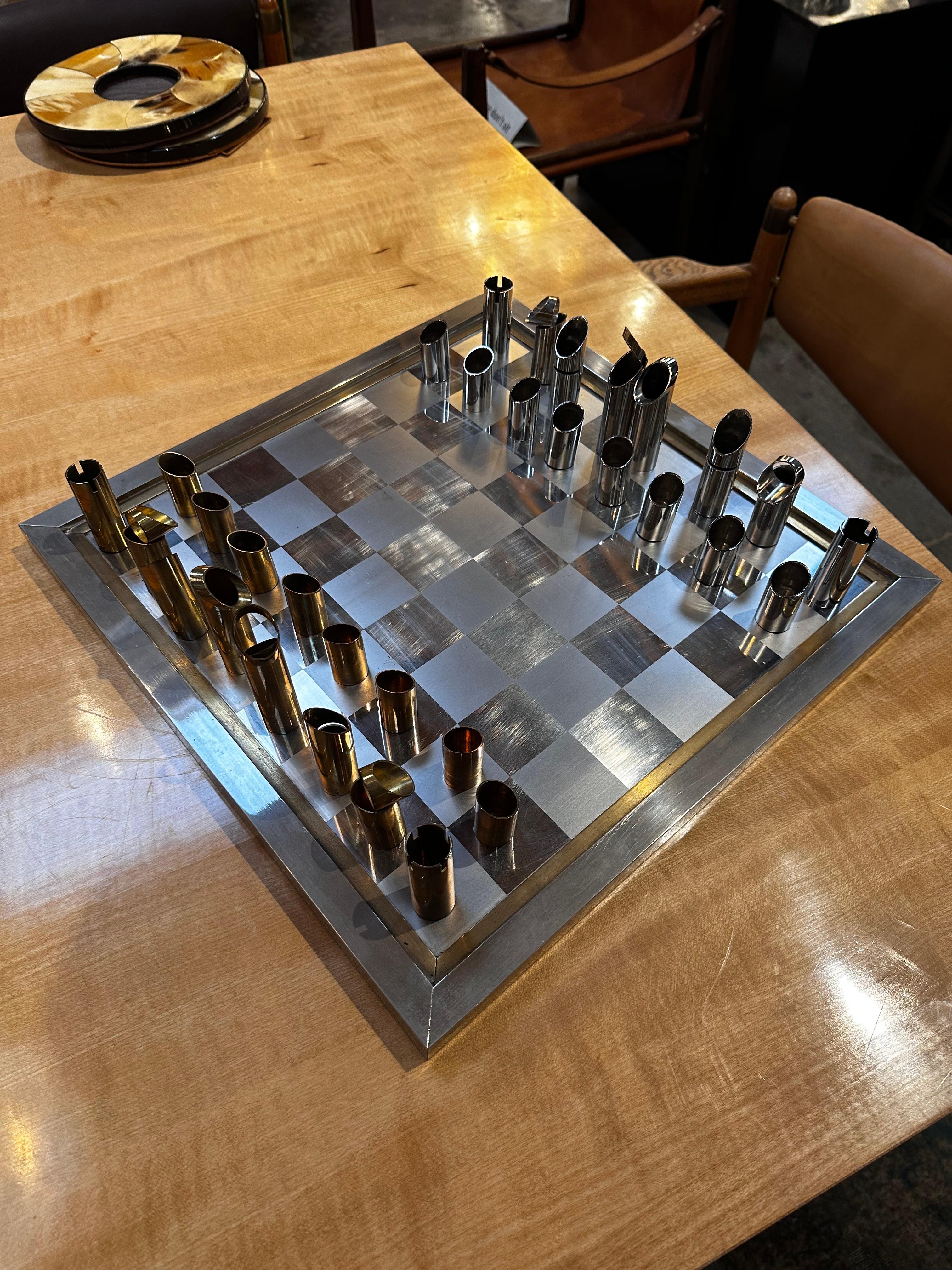 Immerse yourself in the timeless allure of our Rare Chrome and Brass Italian Chess Set by Romeo Rega, a masterpiece from the 1970s. Meticulously crafted in Italy, this extraordinary chess set bears the hallmark of Romeo Rega's iconic design. The