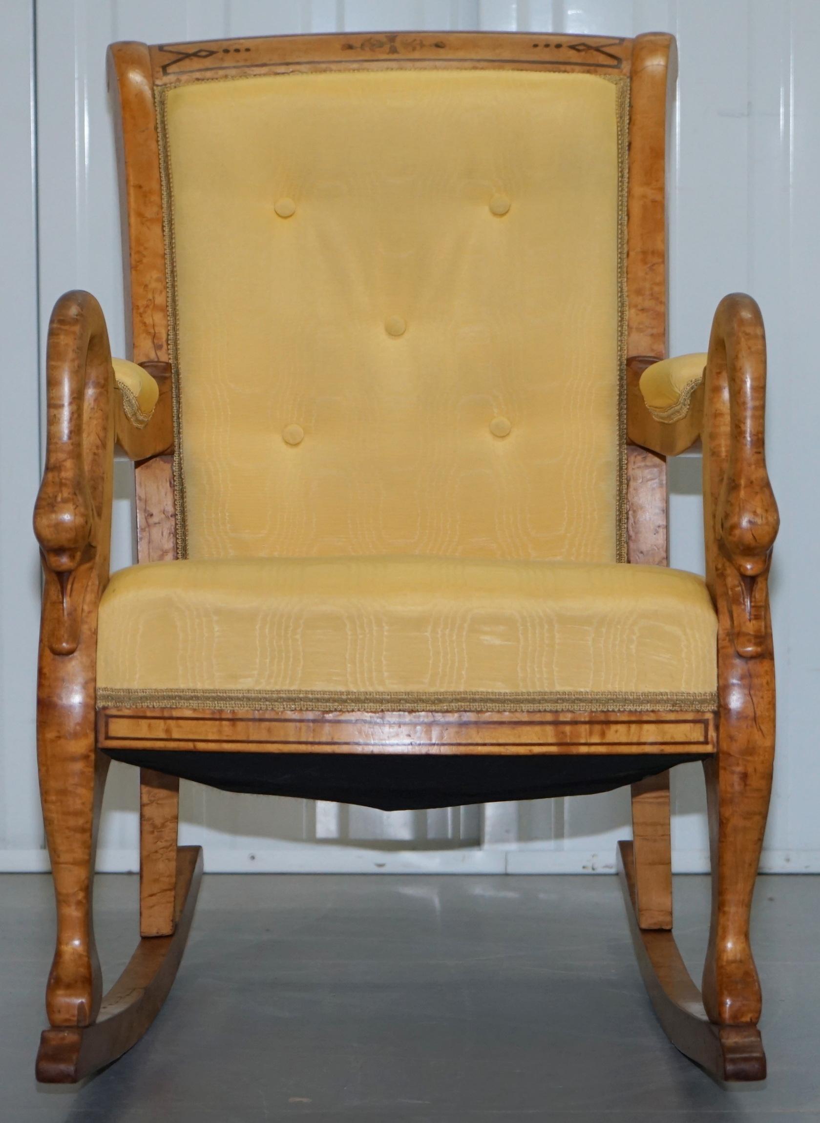 We are delighted to this very rare original Charles X circa 1825 hand carved rocking chair depicting swans heads on the arms

This is one of the best looking armchairs I have ever seen, hand carved from solid Burr Maple depicting Swans heads to