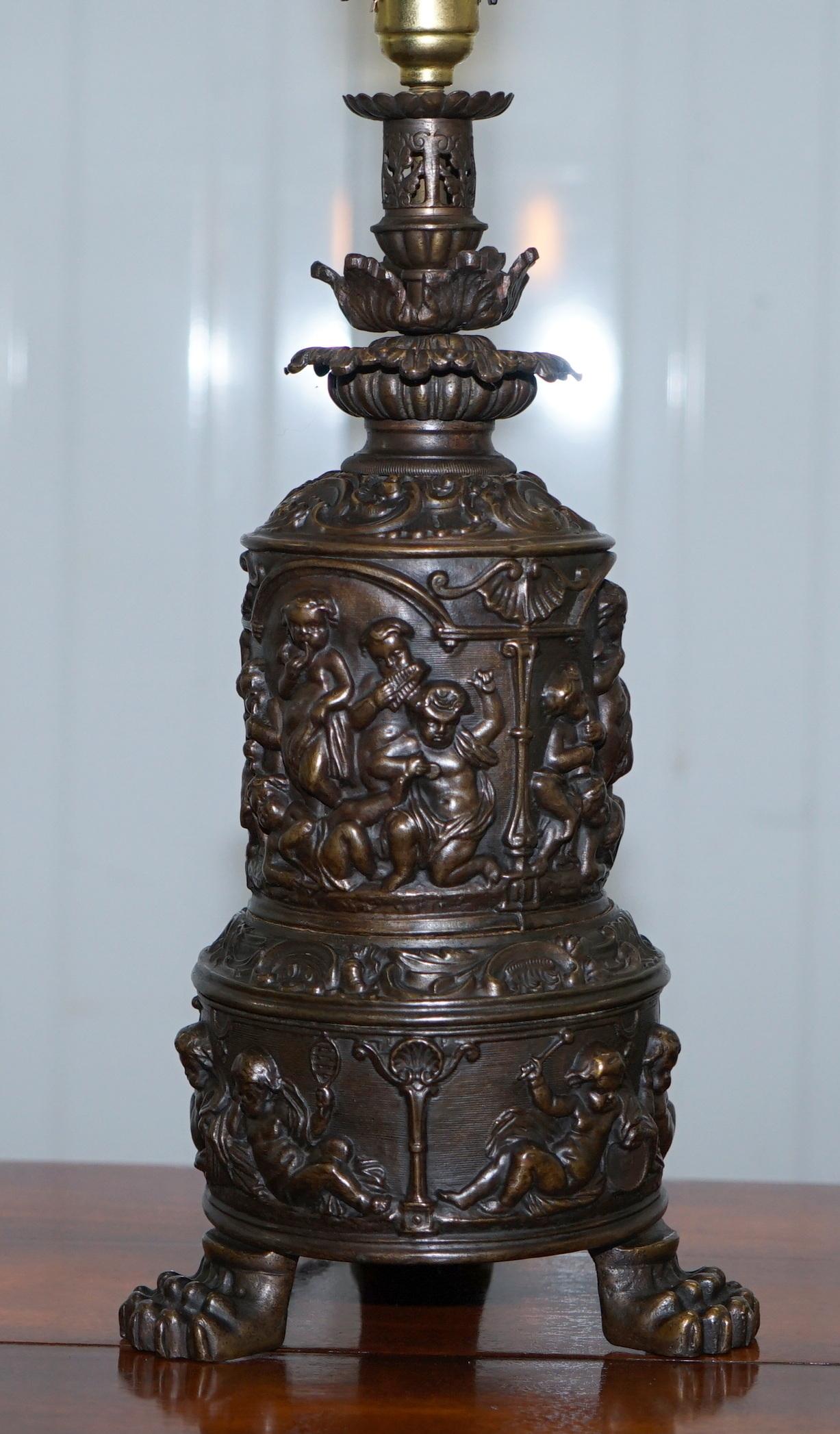 We are delighted to offer for sale this lovely fully serviced circa 1860 bronzed oil lamp converted into a table lamp, the pressed metal cylinders depicting Cherub Angels 

A very good looking decorative and functional lamp, the lamps is covered