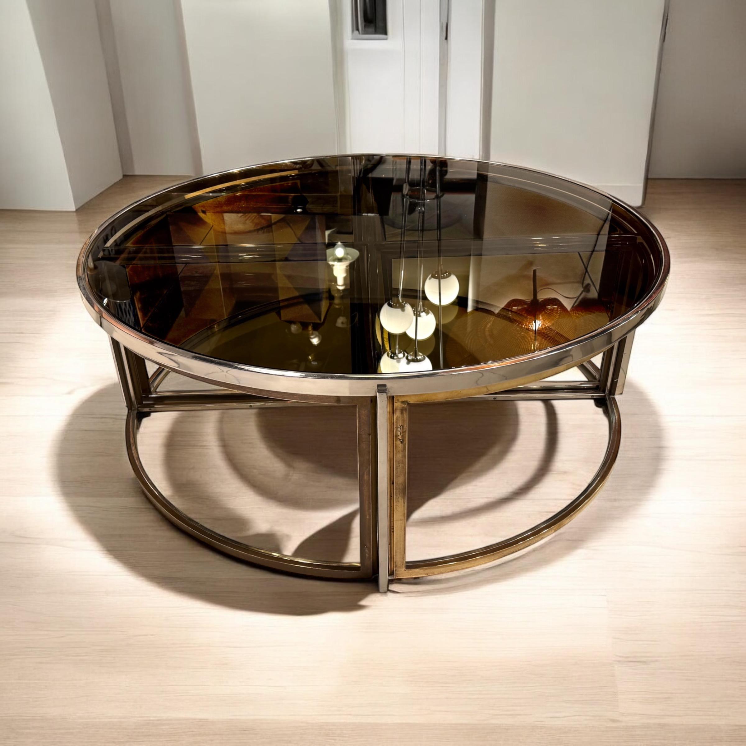 Rare circular coffee table by Jean Charles France 1970, included 4 side table F, chromium plated steel, brass and glass construction. Bicolour finish.
A set of nesting tables consisting of five parts that can be variably combined.
All the smoked