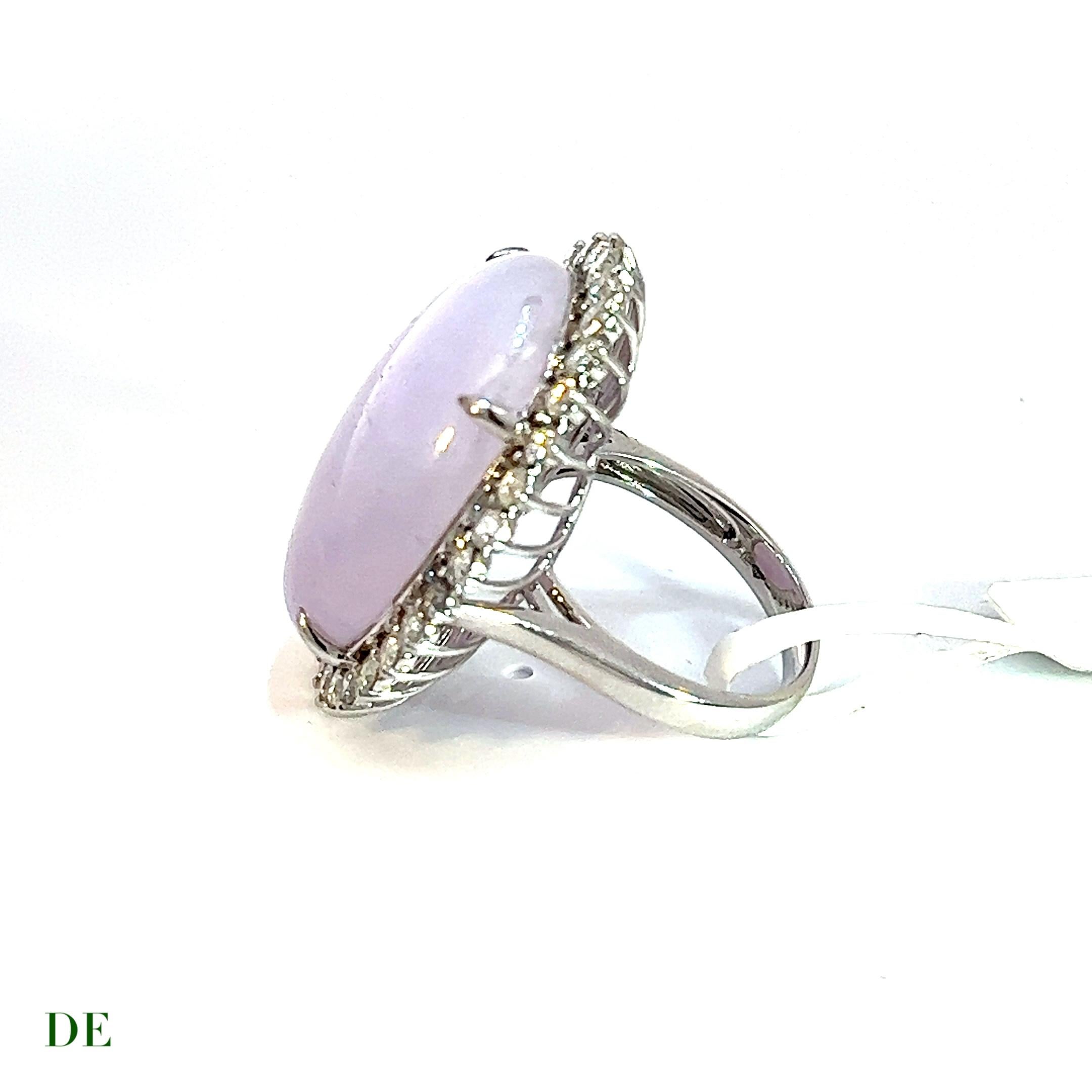 This rare and classic lavender jade and diamond cocktail ring is a true masterpiece that exudes luxury and elegance. The centerpiece of the ring is a stunning lavender jade gemstone that weighs an impressive 29.95 carats and boasts a soft and