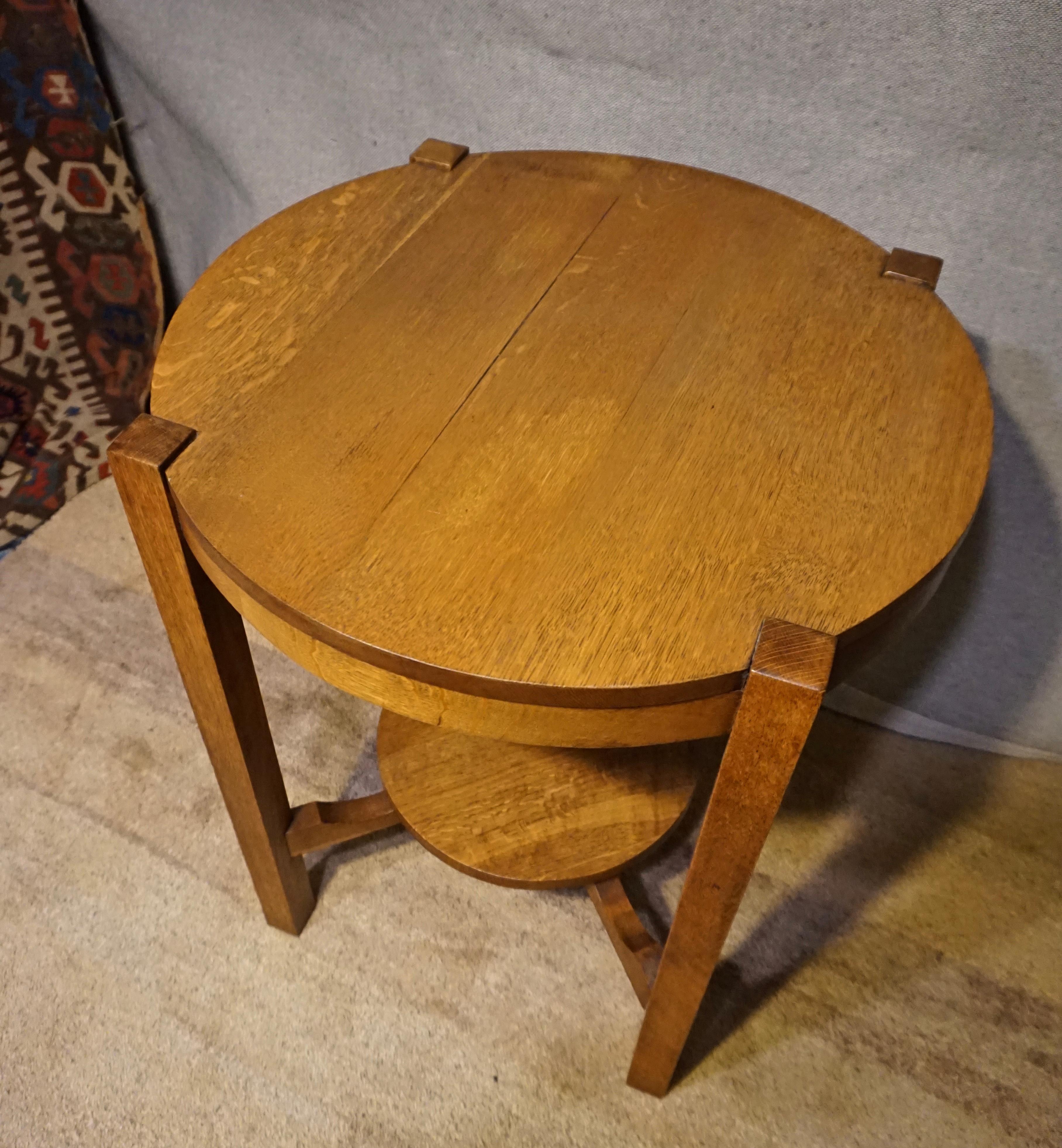 Quality Arts & Crafts solid quarter sawn side table. Fine joinery work and original honey patina. Serial mark ed. Two tiered. Turning brass joinery to aid in expansion/contraction.