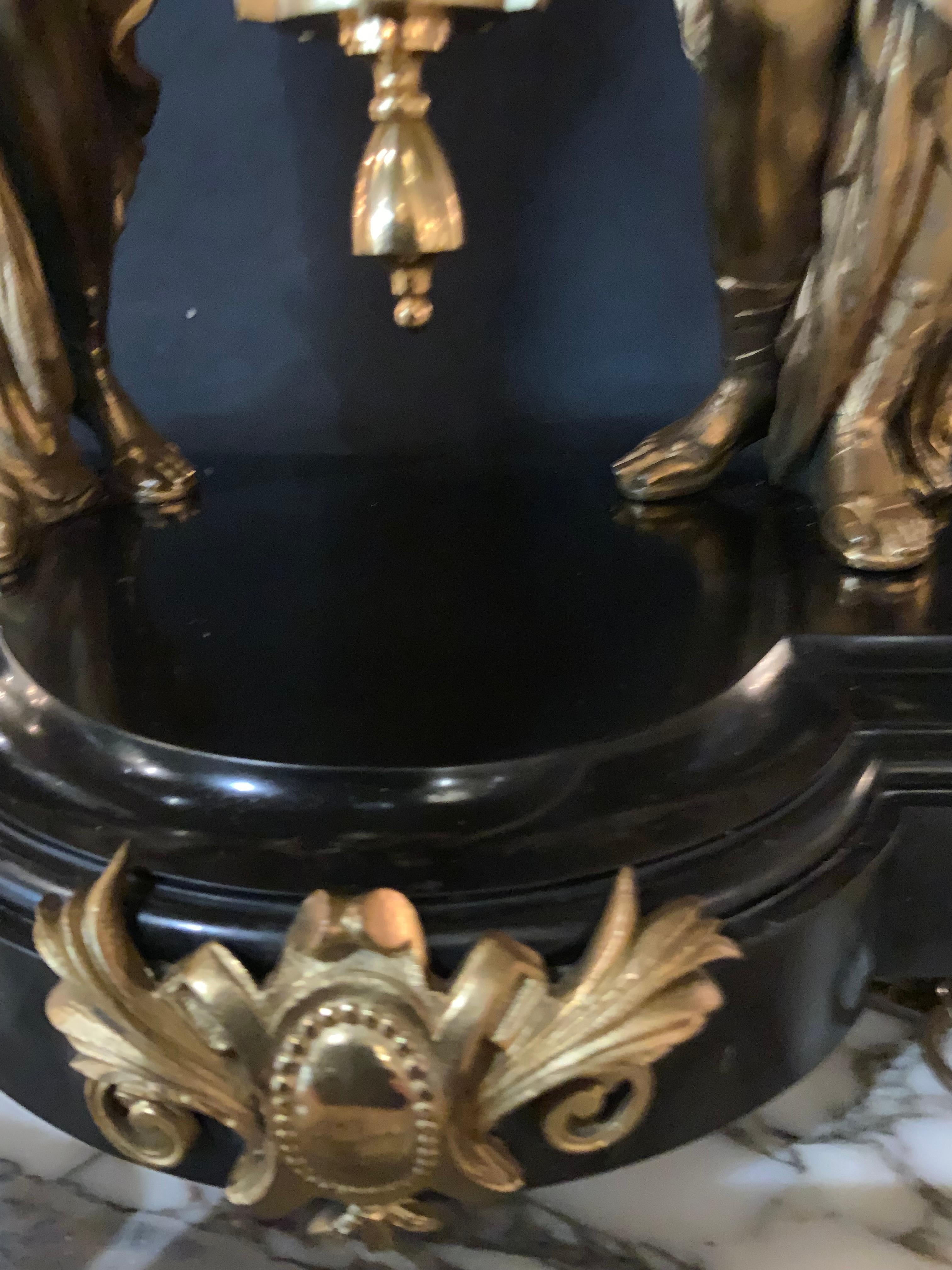 This is a rare clock by Jozse Lechner  in Budapest Hungary
He was known as a creative genius. This clock depicts
Two women holding the clock works above their heads
With an open escapement. The pendulum hangs beneath 
By a long stem and at the base