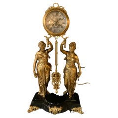 Raro orologio di Jozsef Lechner in bronzo dorato e marmo nero, pendolo rotante