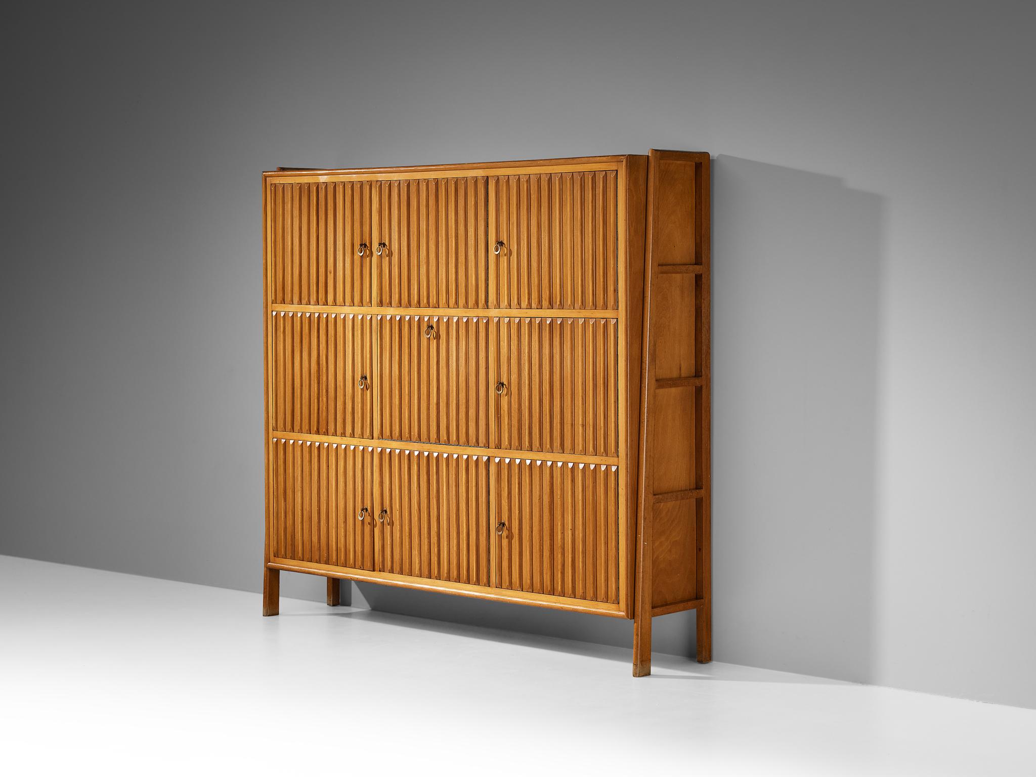 C.M. Varos for Casa Moderna, sideboard, stained beech, glass, brass, Italy, 1959

This unique mid-century bookcase is designed by C.M. Varos for Casa Moderna and crafted in 1959. The defining features of this piece are the intricately carved