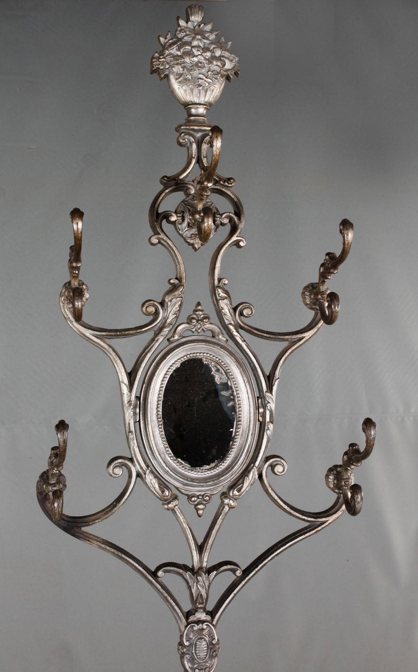 Very rare cast iron, screwed in several parts, with rotatably mounted mirror, seven hooks and umbrella stand with white enameled insert, signs of age, dimensions 210 x 60 x 25 cm. Manufactured in France in Charlevielle by comp. Alfred Corneau, circa