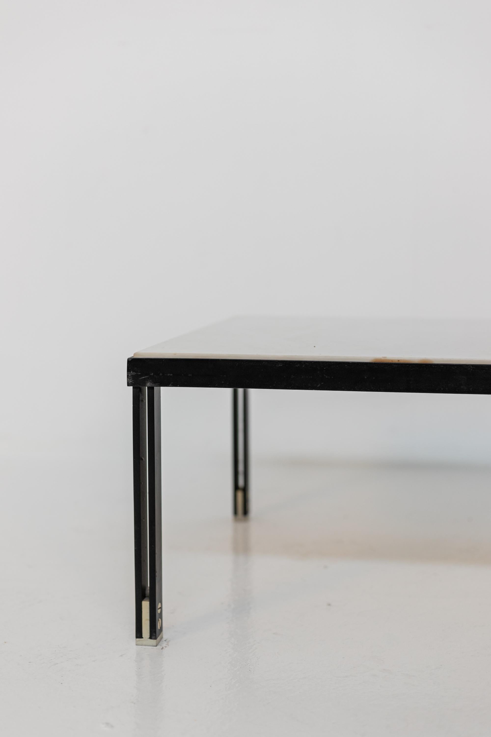 Important and large coffee table attributed to the great designer Gianfranco Frattini of the 1950s. The table comes from a private home and was created on commission. The table has a black iron frame with clean and simple lines. At the feet of the