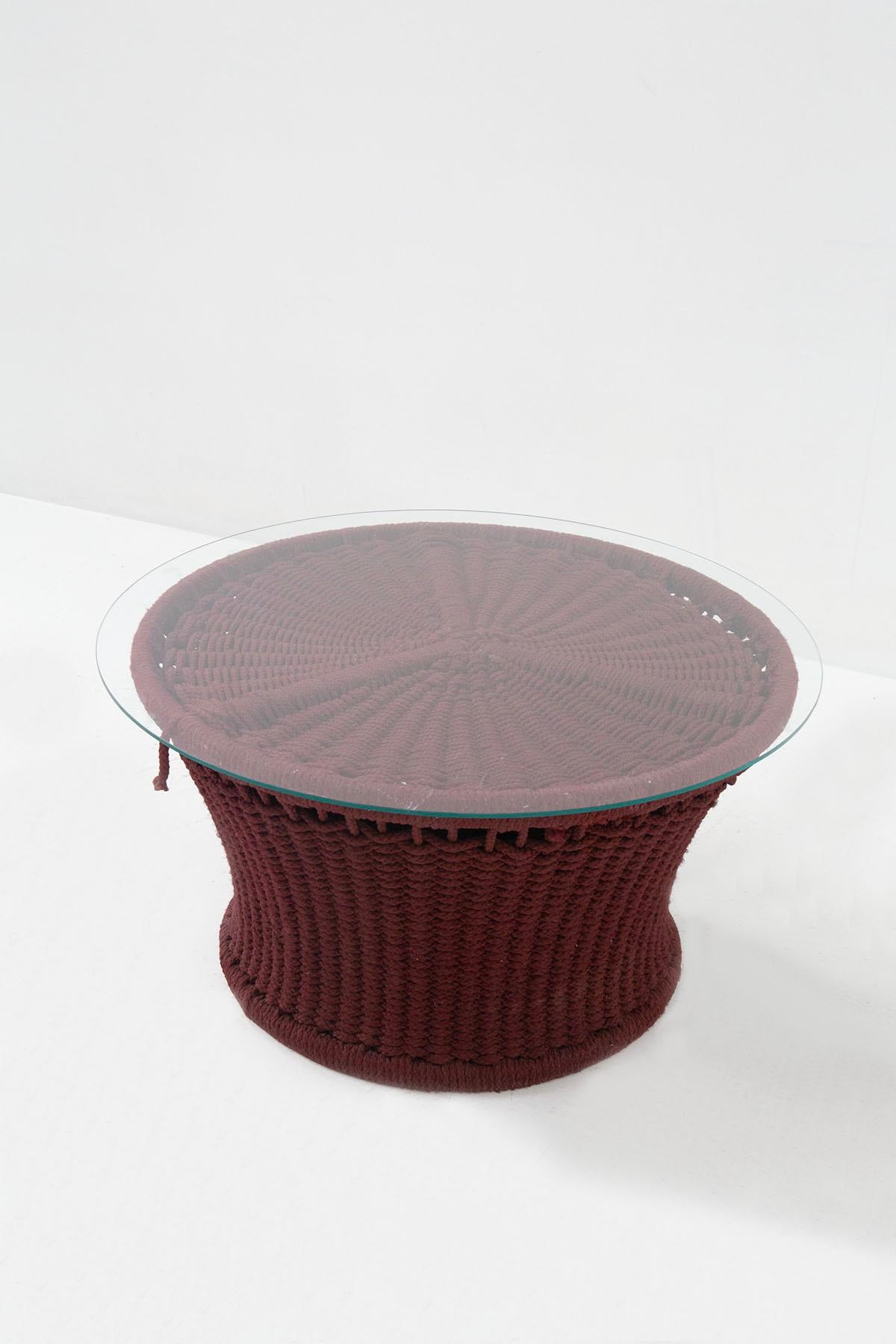 Rare and beautiful coffee table by Marzio Cecchi from the Italian 1970s. The coffee table was made for a hotel on Lake Garda. The product is in excellent condition. Made with an iron frame and wrapped in a thick net of red amaranth-colored rope, the