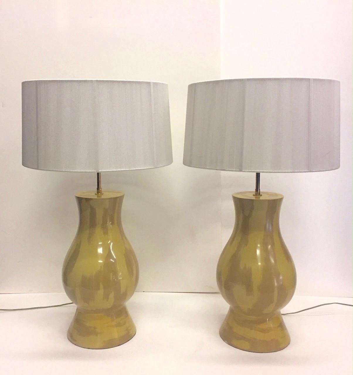 A rare valuable pair of Karl Springer hand painted table lamps in mustard and khaki with an abstract loose zebra-esque pattern.
Adjustable rod, two sockets 60 watt each

Note: String shades optional but will add cost to shipping.