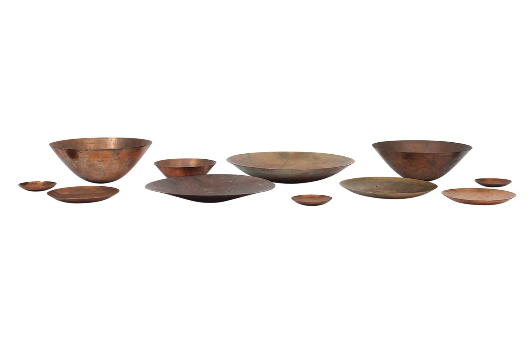 Rare and large collection of hand spun brass and bronze chargers and bowls by American artist Ronald Hayes Pearson. Primarily a jeweler, Pearson used different alloys of metal in his spun vessels giving each piece a unique coloration and patina.