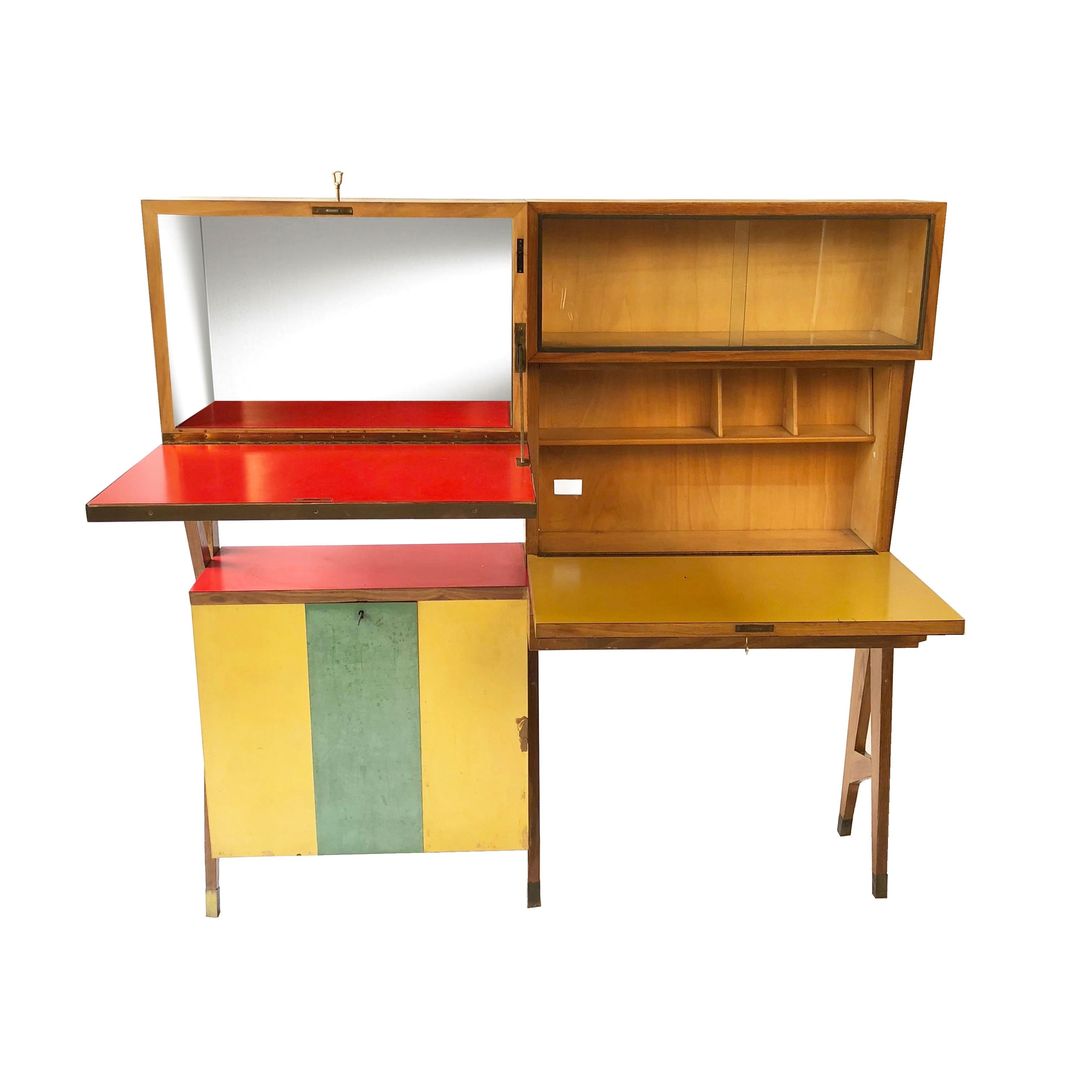 Particular dry bar cabinet in wood covered with formica, Italy, circa 1950.
The left upper cabin contains a mirror which lights up at the opening.
The left lower cabin is composed by a lockable door which reveals two shelves.
The right upper part