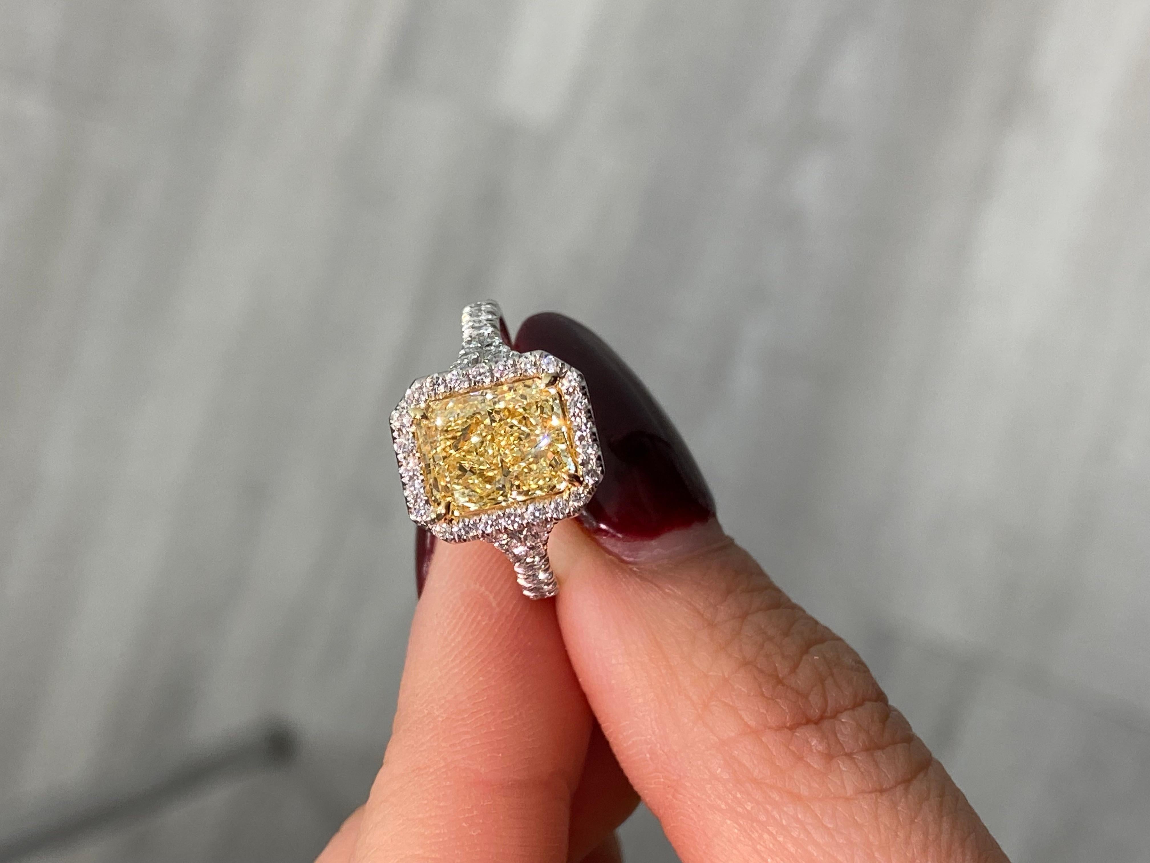 This exquisite halo engagement ring brings modern sophistication to a timeless design. At its center is a 2.51-carat Light Yellow diamond in the U-V range, boasting a captivating hue and VS2 clarity, making it a true standout.

Enhancing its