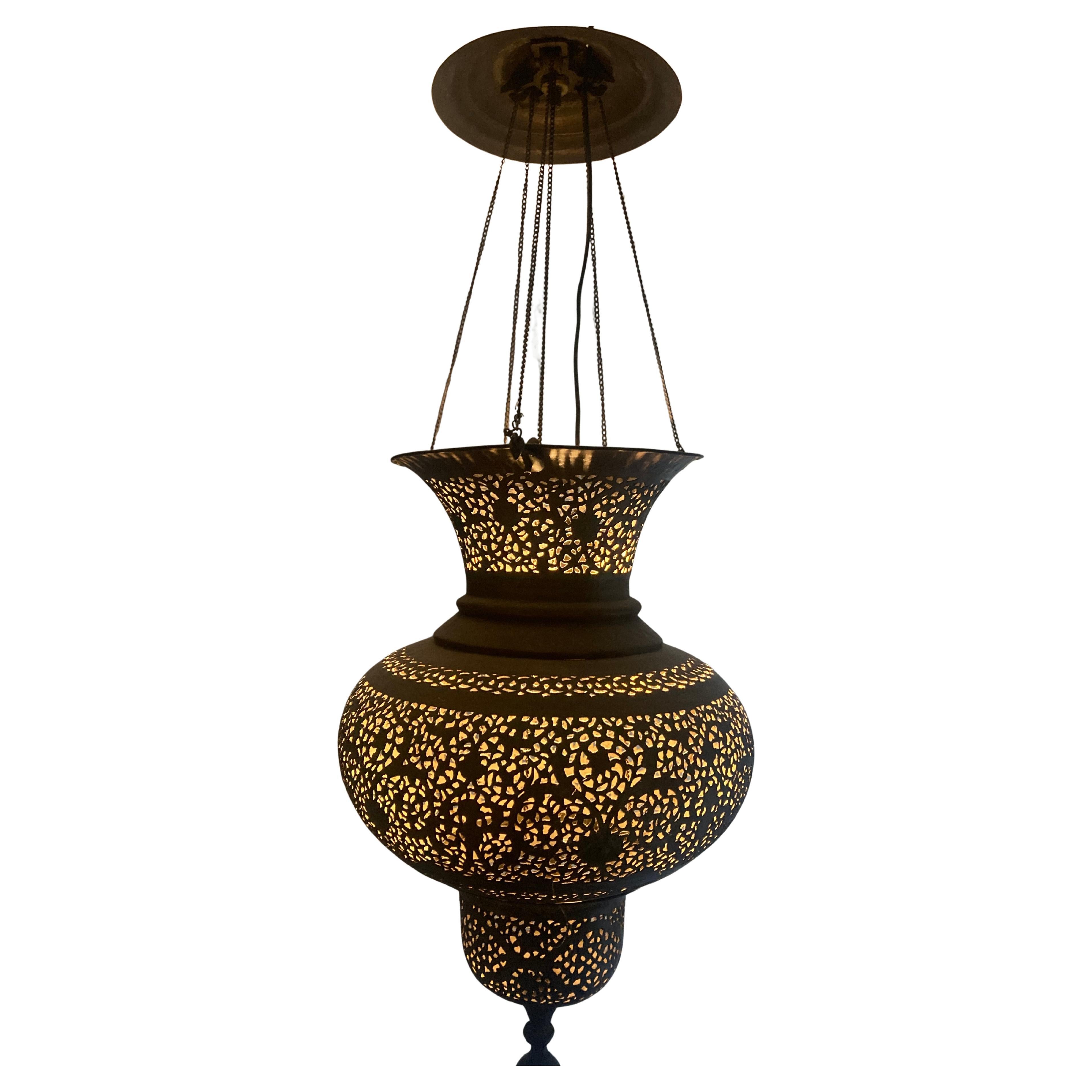 Beautiful  mosque lamp from the 19th century. with its original chains and canopy. With the perforation in the metal the light radiates in the room.