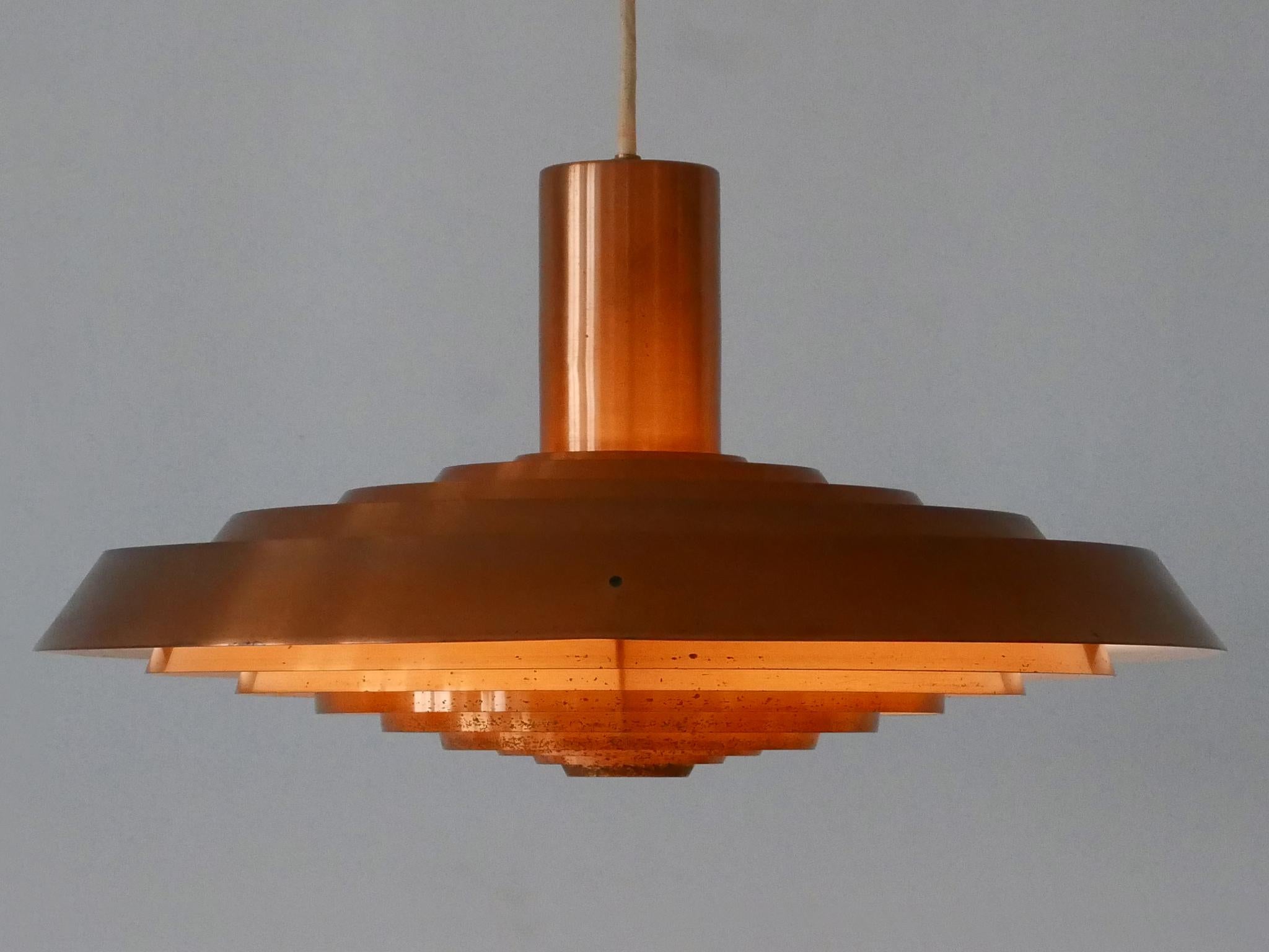 Extremely rare, highly decorative and elegant Mid-Century Modern 'Plate' or 'Tallerken' pendant lamp or hanging light. With wonderful light effect. Designed by Poul Henningsen for Louis Poulsen, Denmark, 1958. 
Makers mark inside the dome which hold