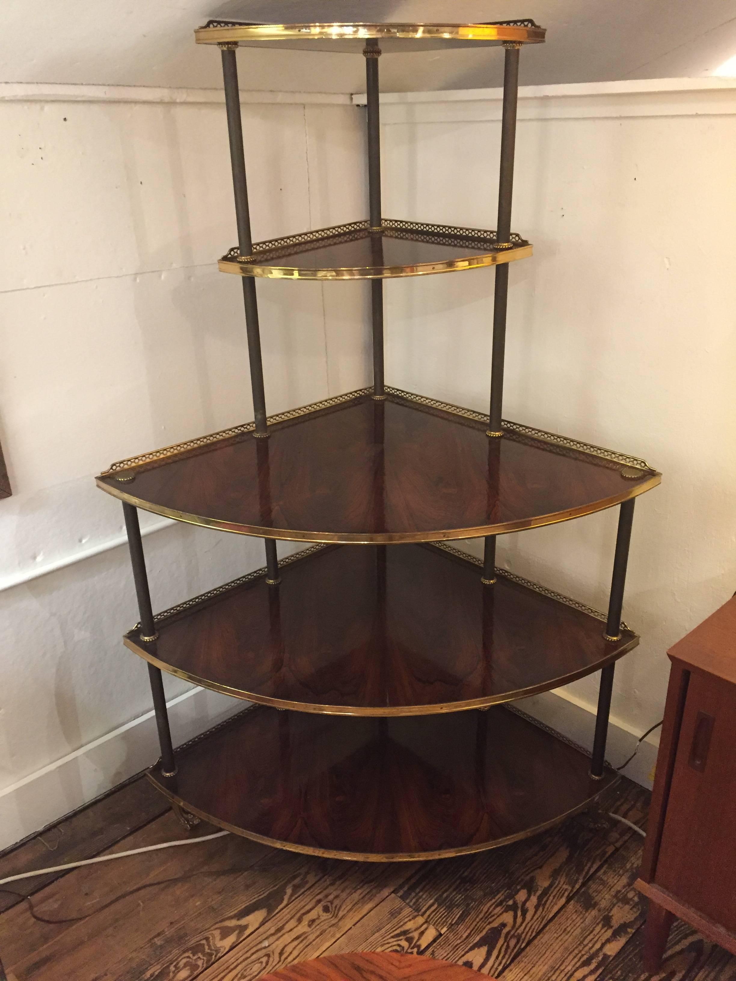 Wonderfully elegant corner shelving display unit having five levels of mahogany tiers framed with brass galleries and lovely columnar structure finished with handsome brass feet. Great for displaying or using as a server in a dining