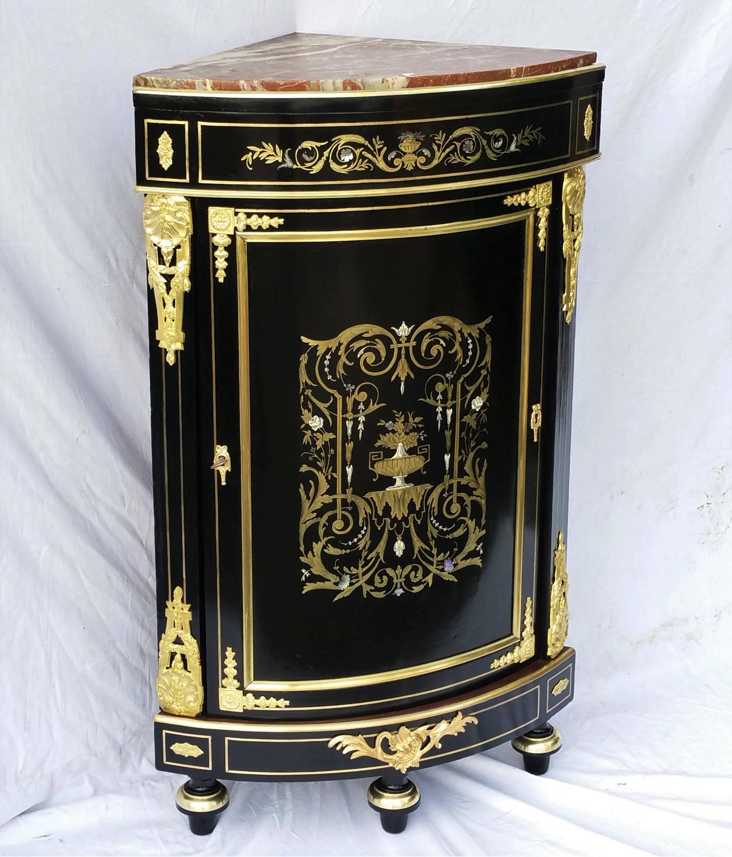 Very rare model of a corner cabinet in Boulle style marquetry beautifully decorated with brass, bones and mother-of-pearl.
Gorgeous gilt polished bronze and the inside part in mahogany color with one shelf and its key.
Griotte marble in good