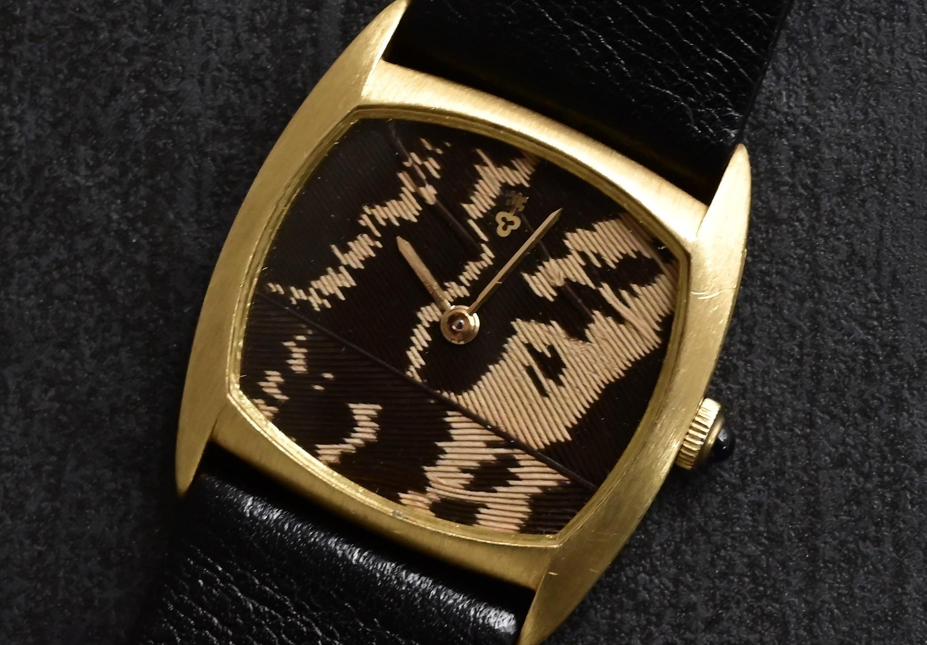 eBay Title:
 Rare Corum 18K Yellow Gold Peacock Feather Dial Watch 30x27mm Manual Wind w/ Original Buckle
eBay Description:
 This rare and striking Corum wristwatch is a true collector’s piece, showcasing a stunning peacock feather dial housed in a