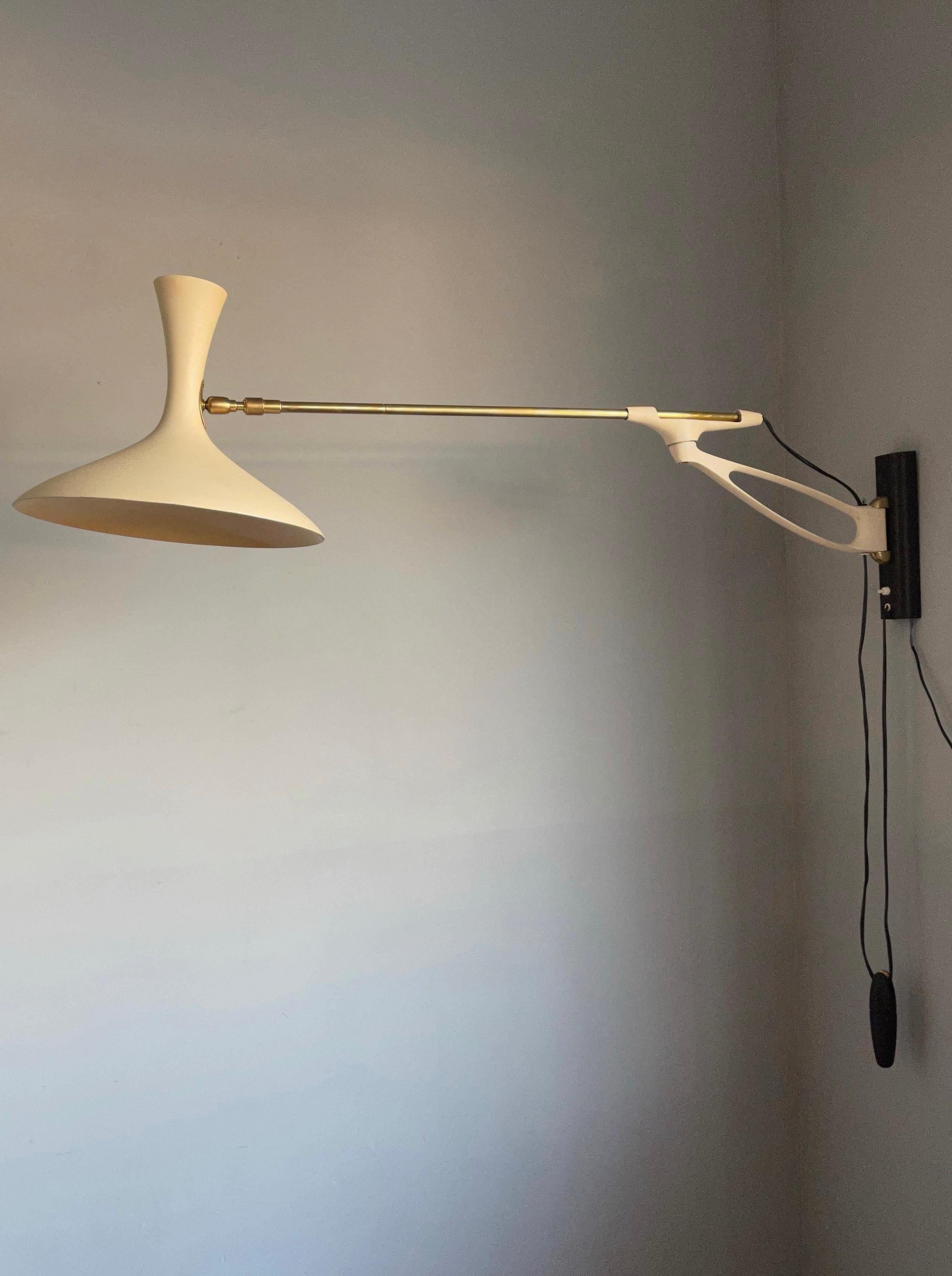 Wonderfully stylish and pleasing to the eye swing light, easy to wall mount.

This rare design wall lamp from the midcentury era is by Louis Kalff and it was manufactured by Gebrüder Cosack Leuchten, Germany. For the collectors of rare and great