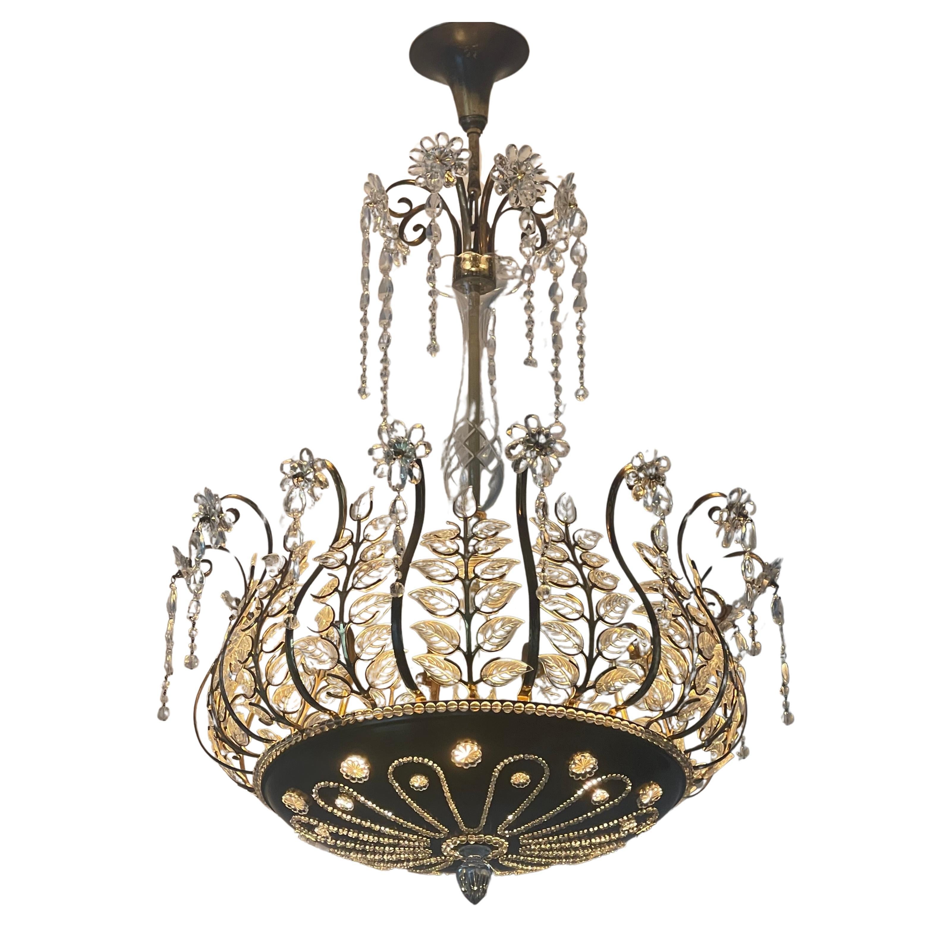 An amazing and very  rare six-light clear glass and crystal flower chandelier in the style of Maison Baguès, France, circa 1950s.
This beautiful handcrafted fixture is made of patinated brass, crystal, and clear glass.
Socket:  6 x E27 or E26 (US) 