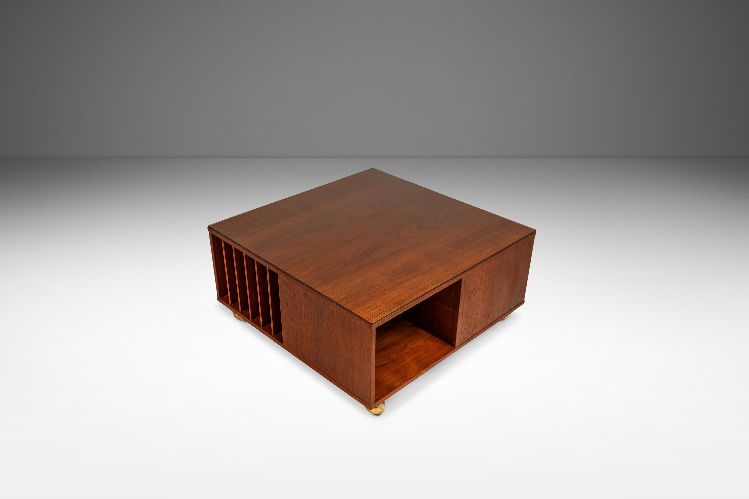 Equal parts function and artistry this visually stunning coffee table, designed by the highly influential Peter Løvig Nielsen, features clever storage spaces cut into all four sides of the cube. With two slender drawers, a six-bay magazine rack and