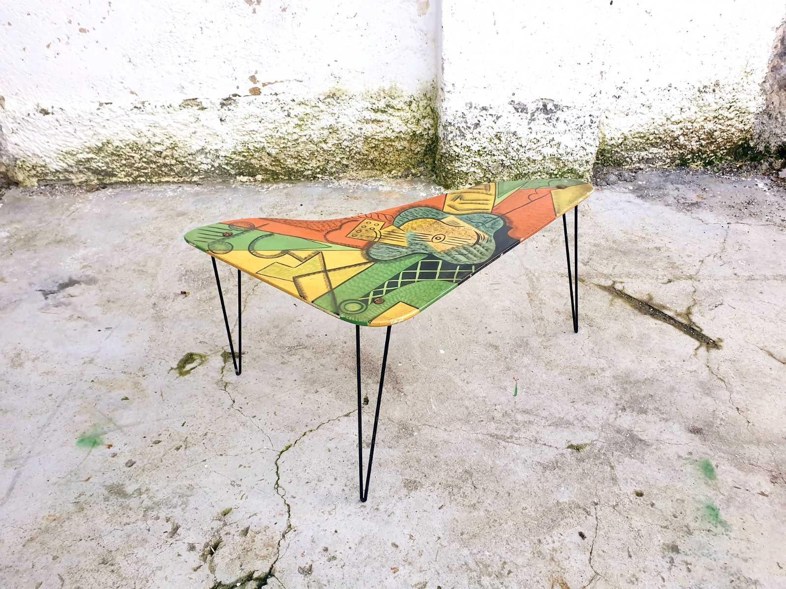 Very Unique and Rare Coffee Table, with famous Picasso guitar on the top. It is made in France in '60s, by unknown artist.

The Table is made of three black metal legs and painted top.
This Coffee Table table is in good vintage condition, with small