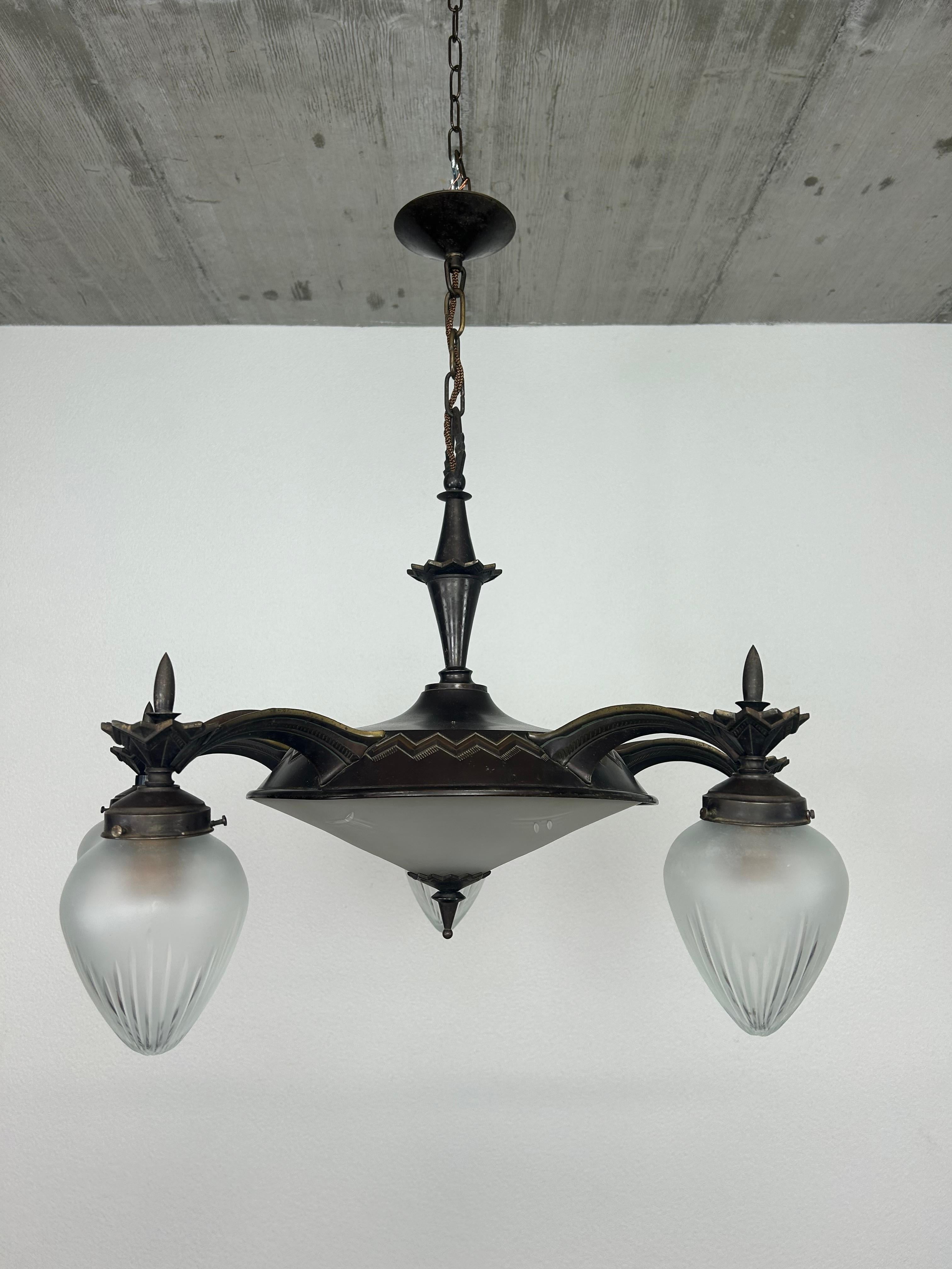 Rare cubist bronze chandelier with glass lampshades in excellent original condition.