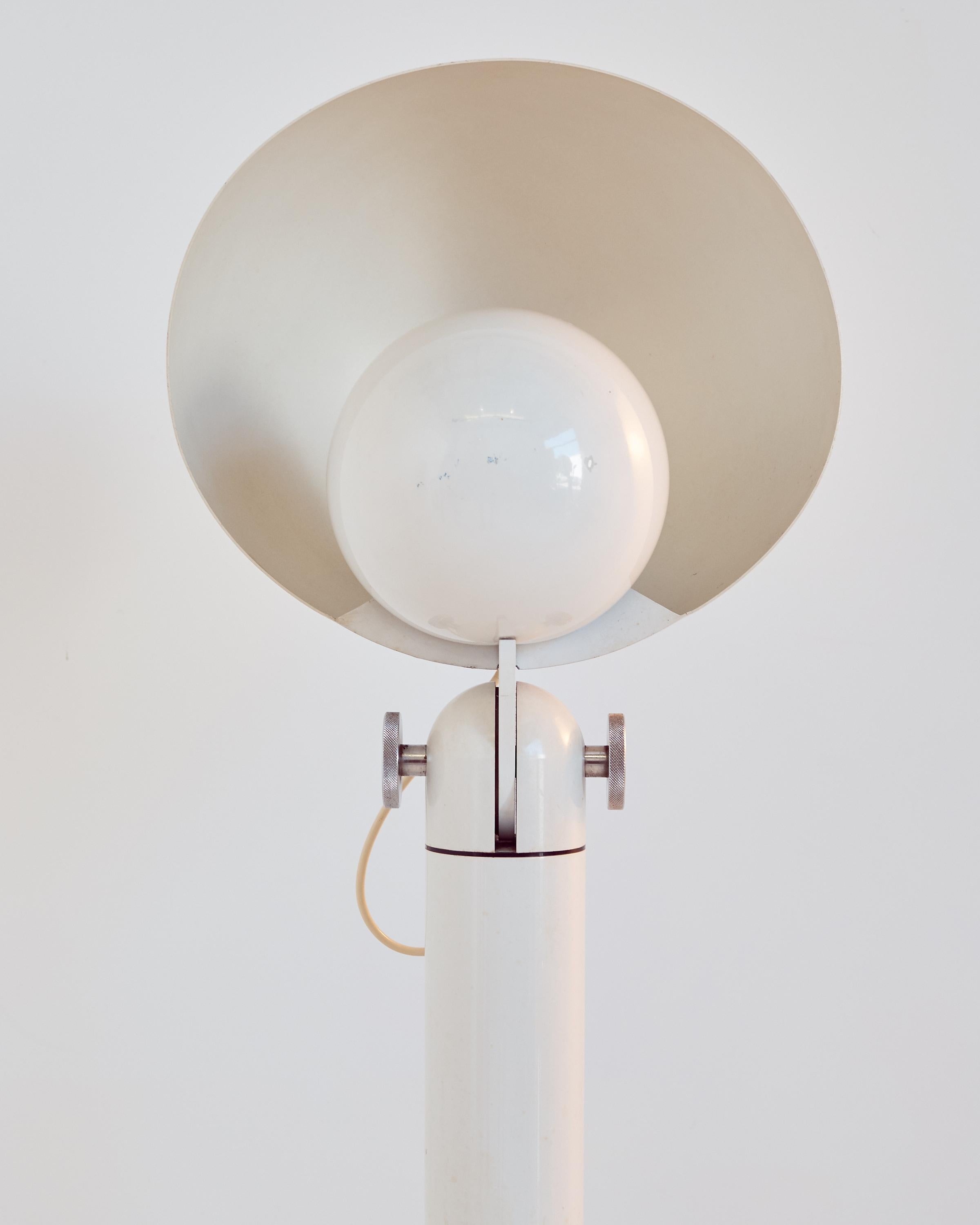 This Postmodern lamp is made of white-painted aluminum. The semicircular shade can be adjusted with large chrome screws and the inner shade provides indirect light.