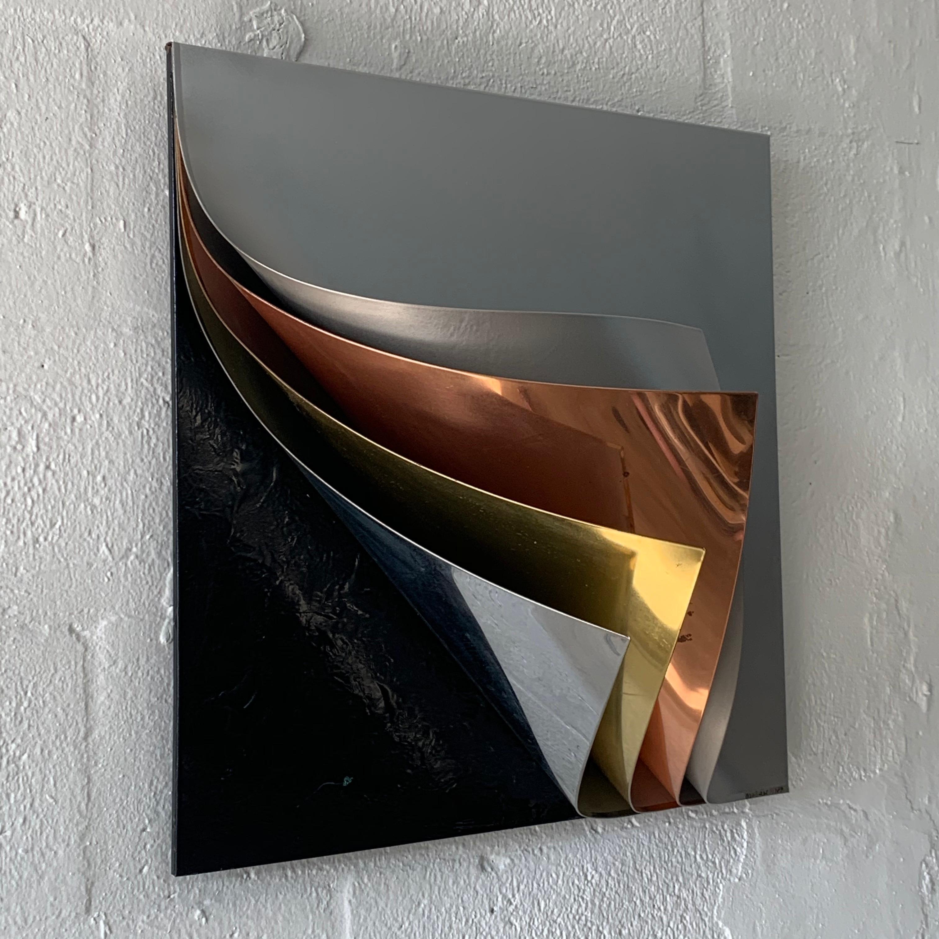 Wall sculpture rendered in gray painted metal polished copper brass and chrome with textured black base by Curtis Jere, 1989, signed, C. Jere.