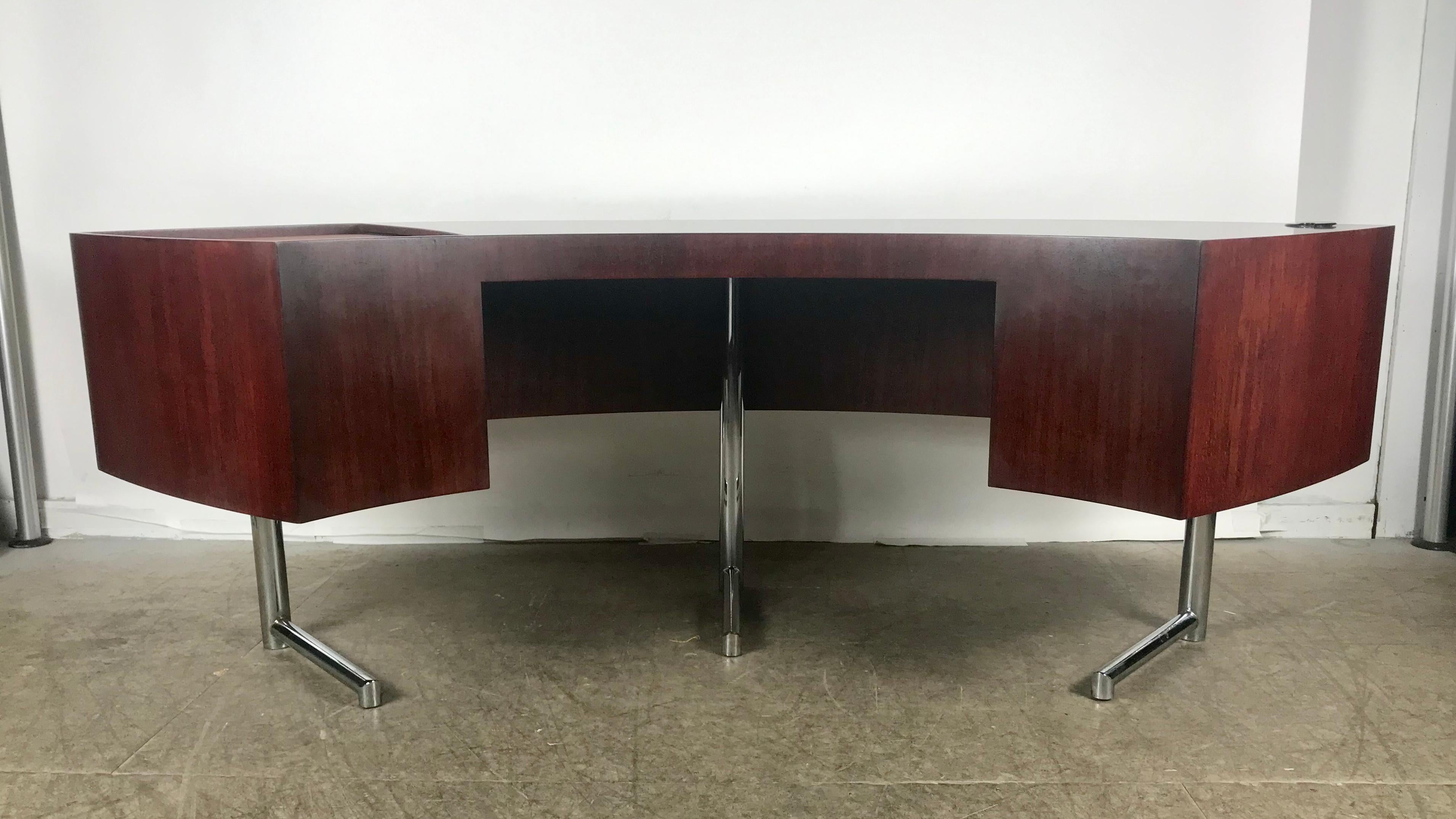 Rare curved desk on chrome plated base. Designed by Leif Jacobsen, Dramatic design, recently restored, teak wood with rosewood stain, leather wrapped sliding door file compartment. Aluminum pencil inlay detail to top, retains original label, Hand