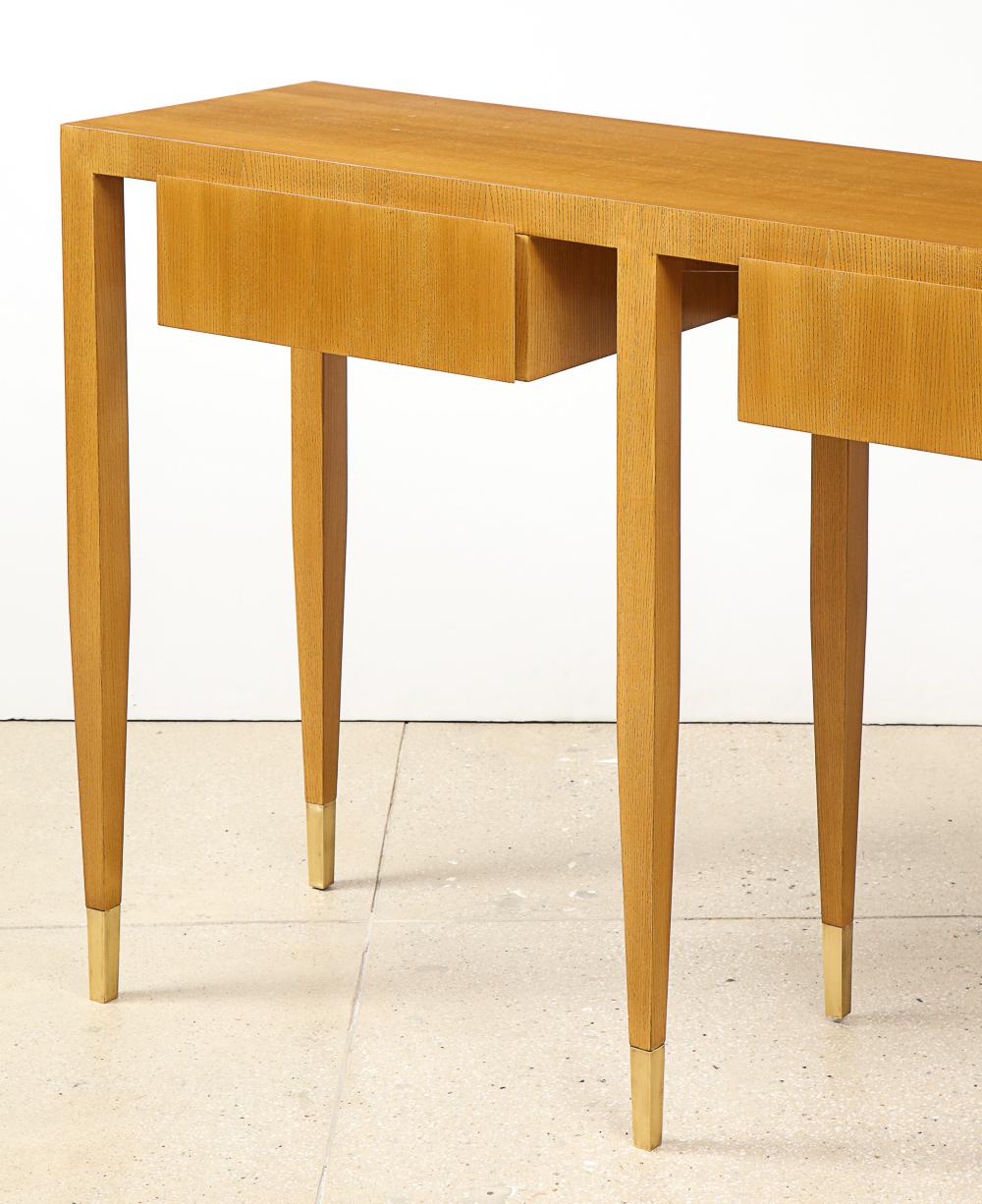 Ash wood with brass feet. Probably produced by Giordano Chiesa. A rare, custom Gio Ponti design with two large drawers, narrow, tapering legs, & brass feet. This piece has been authenticated by the Gio Ponti Archives. Provenance: Private collection,