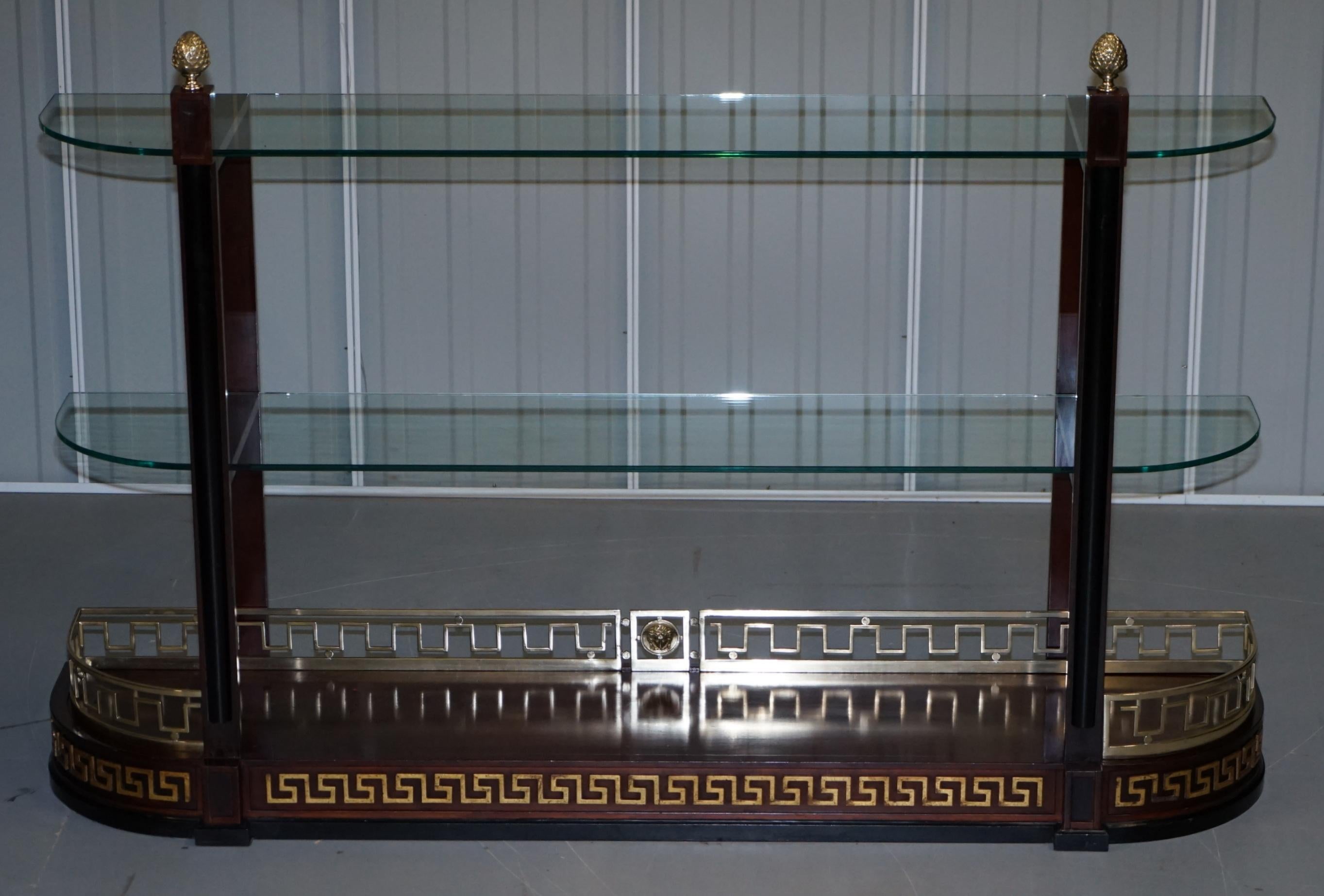 We are delighted to offer for sale this truly stunning custom made to order Versace mahogany and brass console bookcase

A very high end commission, this was ordered around 12 years ago by the then richest lady in England, apparently it cost