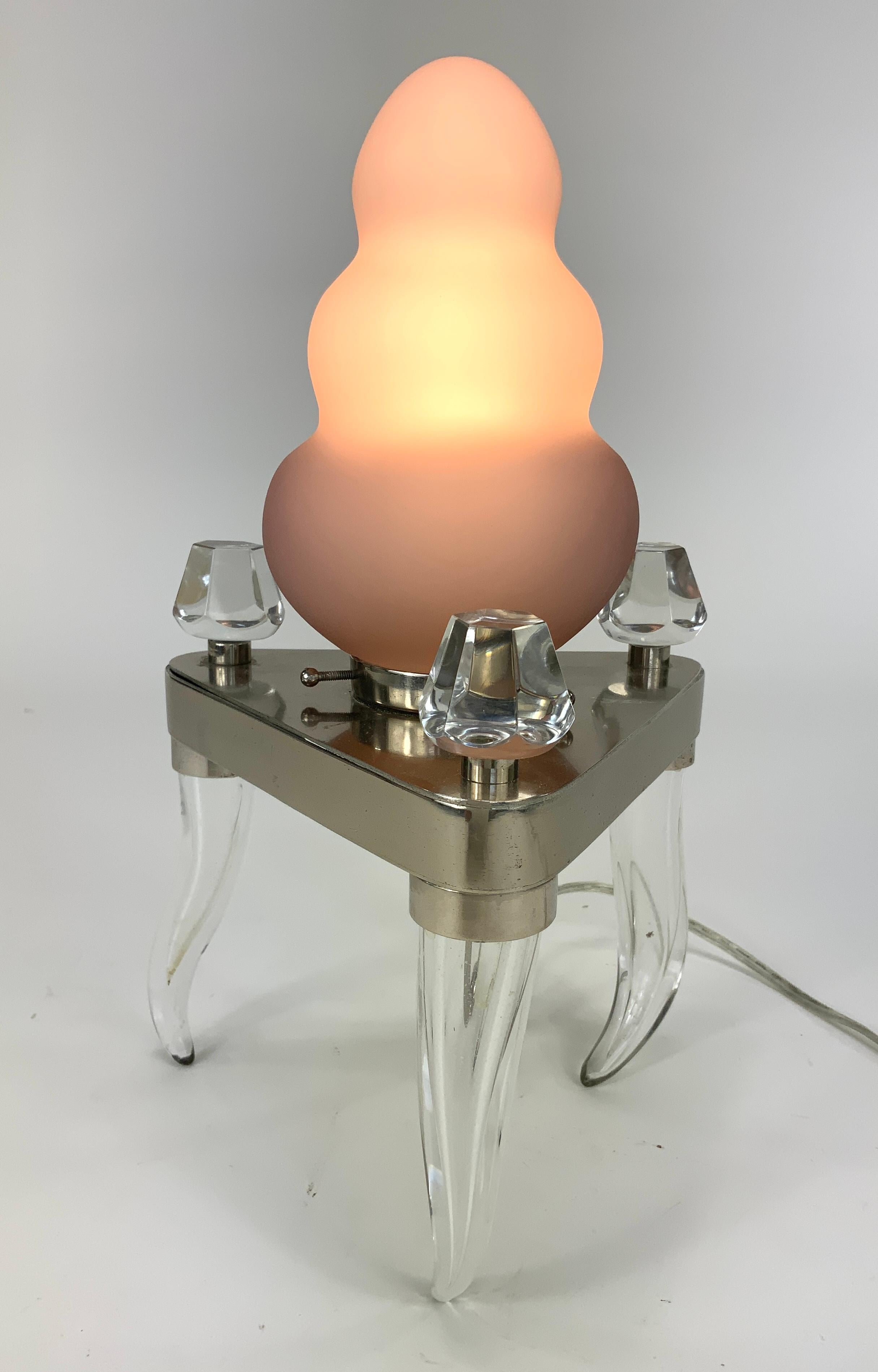 A rare table lamp by the contemporary glass artist and lamp designer Dan Dailey (b.1947) made from chromed steel, clear and sandblasted glass and made to resemble a human molar tooth.

Dan Dailey is considered today as “one of the most unique voices