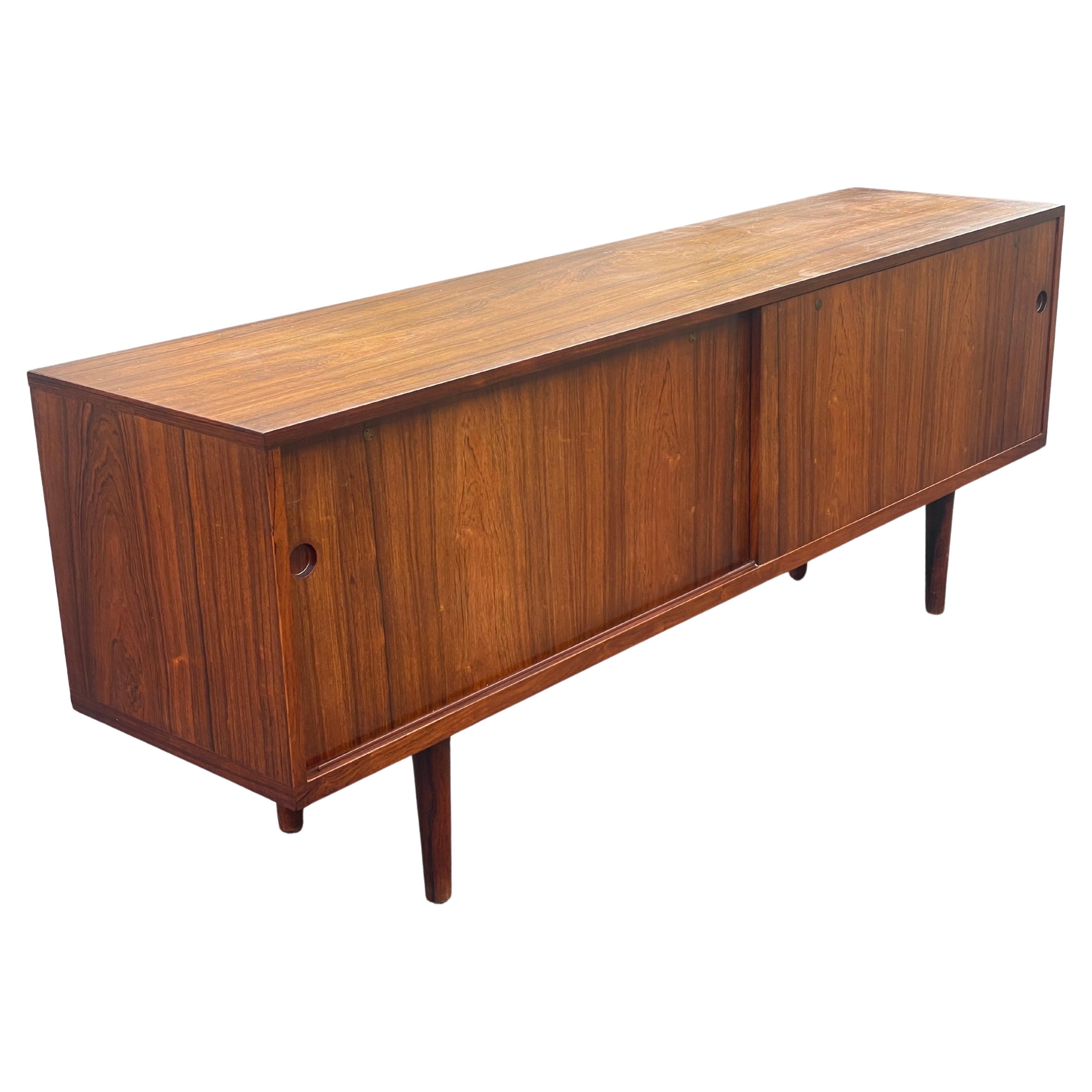Rare Hans Wegner RY-26 Sideboard, a mid-century Scandinavian gem. Measuring 200 cm wide, 49 cm deep, and 79 cm high, this 1950s piece from Ry Møbler, Denmark, showcases luxurious wood and elegant brass accents. Perfect for spacious interiors, it