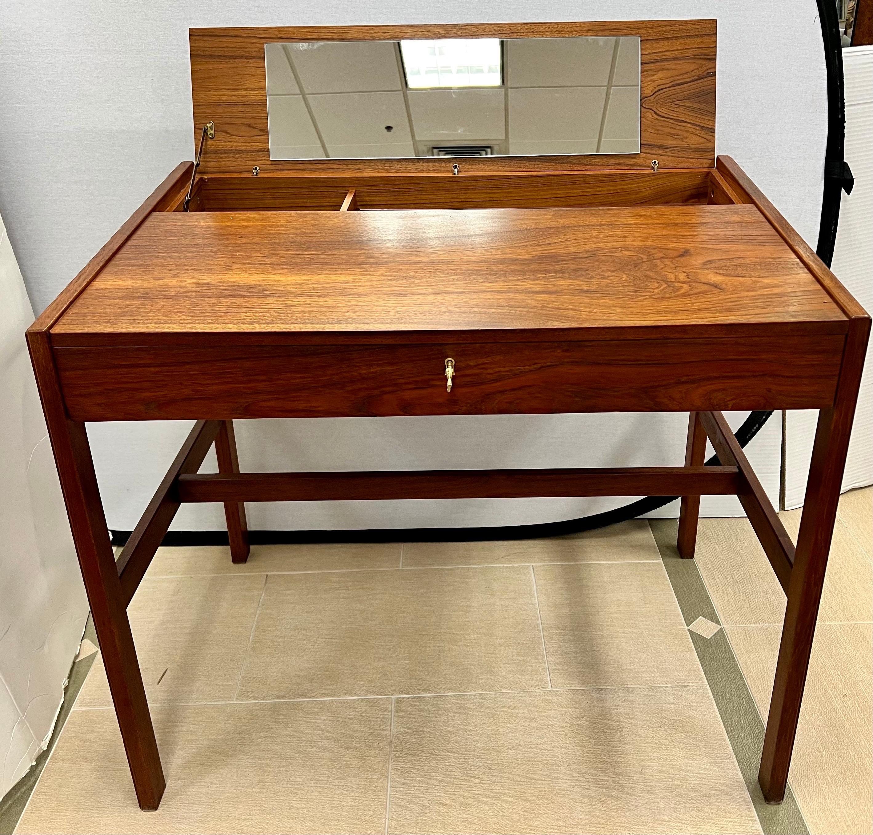 From Finland, this Arne Wahl Danish Control vanity desk features a lift up top with compartments and mirror underneath. Use as a vanity or a desk. Gorgeous lines and great scale. Rosewood throughout. Why not own the best?