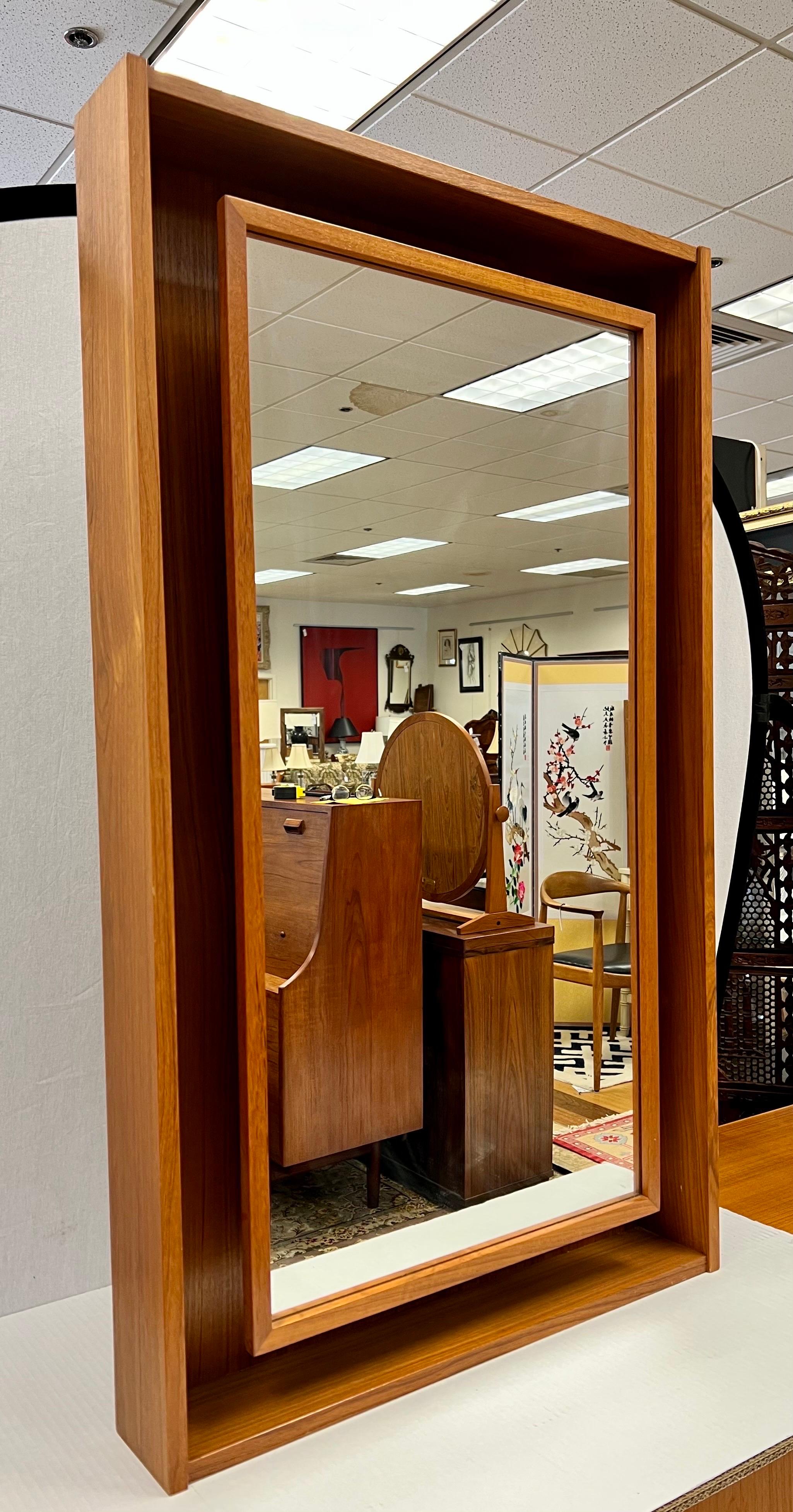 Ultra rare electrified vanity mirror by the famed Danish design team of Pedersen and Hansen. Note the inset mirror and wood craftsmanship around the boarder. Made of teak and electrified with plug at back, see pics. Iconic Danish Modern lines