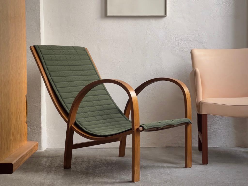 Rare Danish Modern Lounge Chair in Elm designed by Søren Hansen, who was a relative and part owner of Fritz Hansen in the 1940s, is a remarkable piece of mid-century furniture that holds historical and design significance. This lounge chair