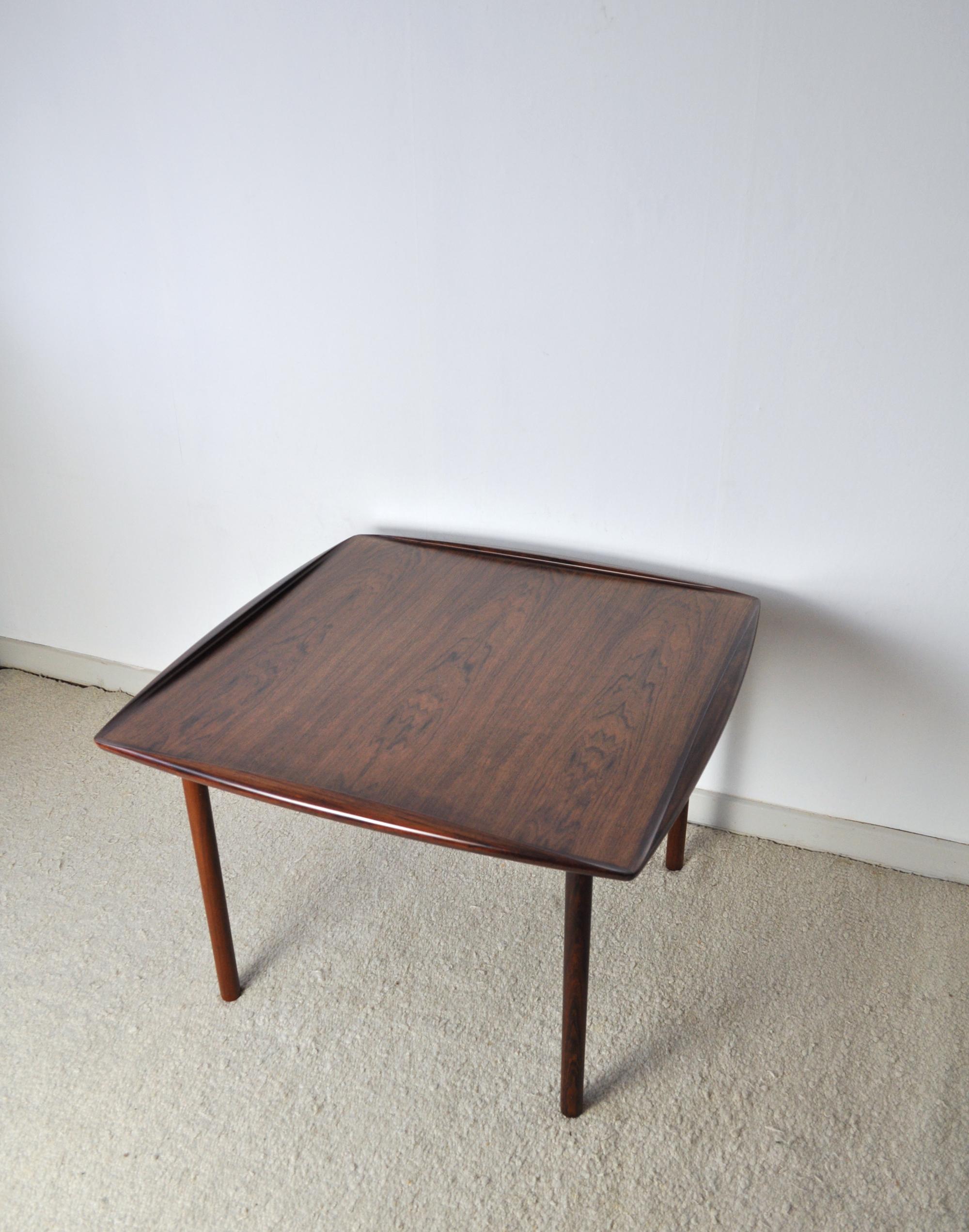 Rare rosewood coffee table designed by Grete Jalk 1959 for P. Jeppesens Møbelfabrik, model G J 108.
Stunning finish with turned edges. Excellent and restored condition.
Labeled by maker and Danish Furniture makers control.
 