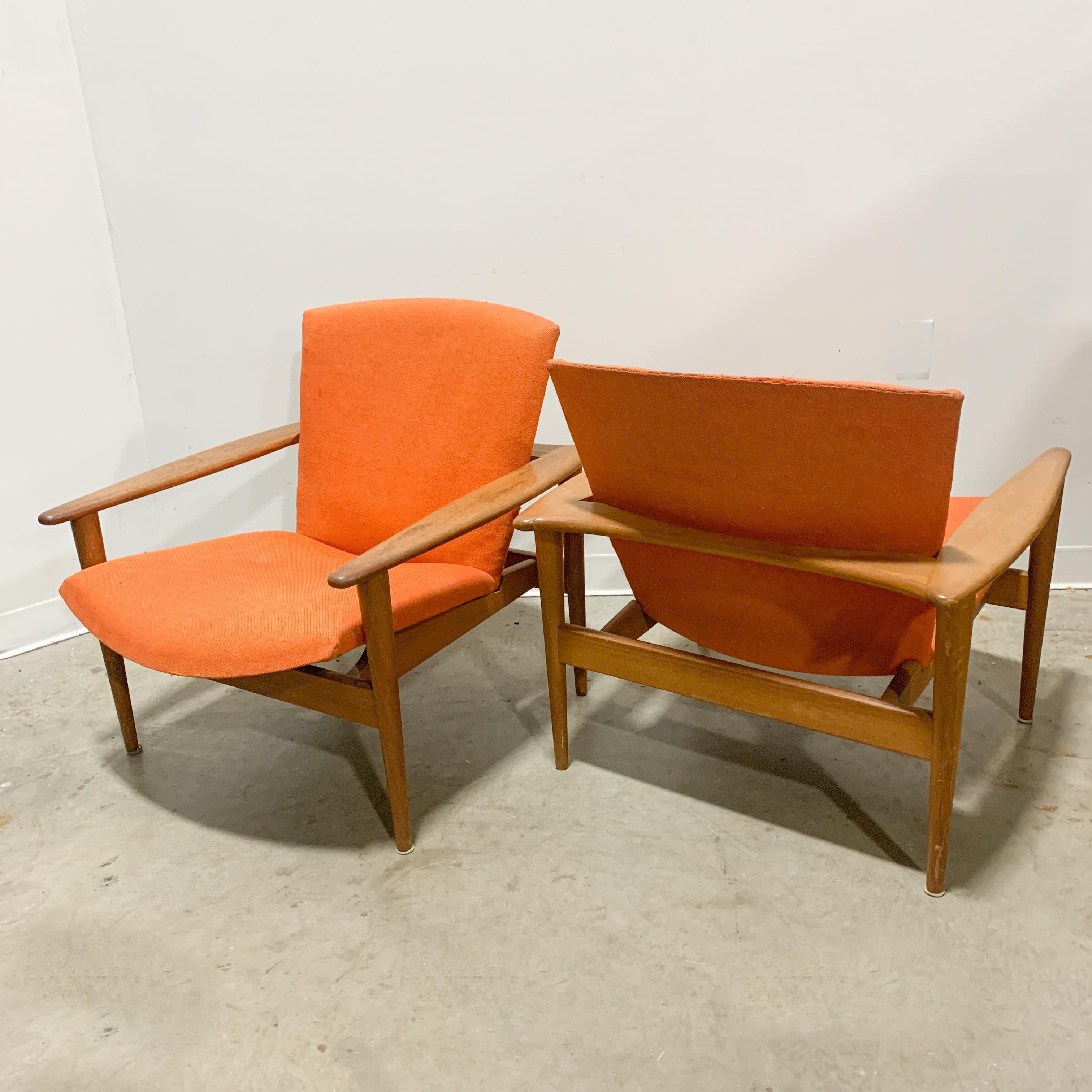 Rare and unusual solid teak lounge chairs probably designed by Arne Hovmand Olsen for Mogens Kold (based on design features, construction details and period image). Fantastic spear arms and a unique wrap-around form. High-quality craftsmanship and
