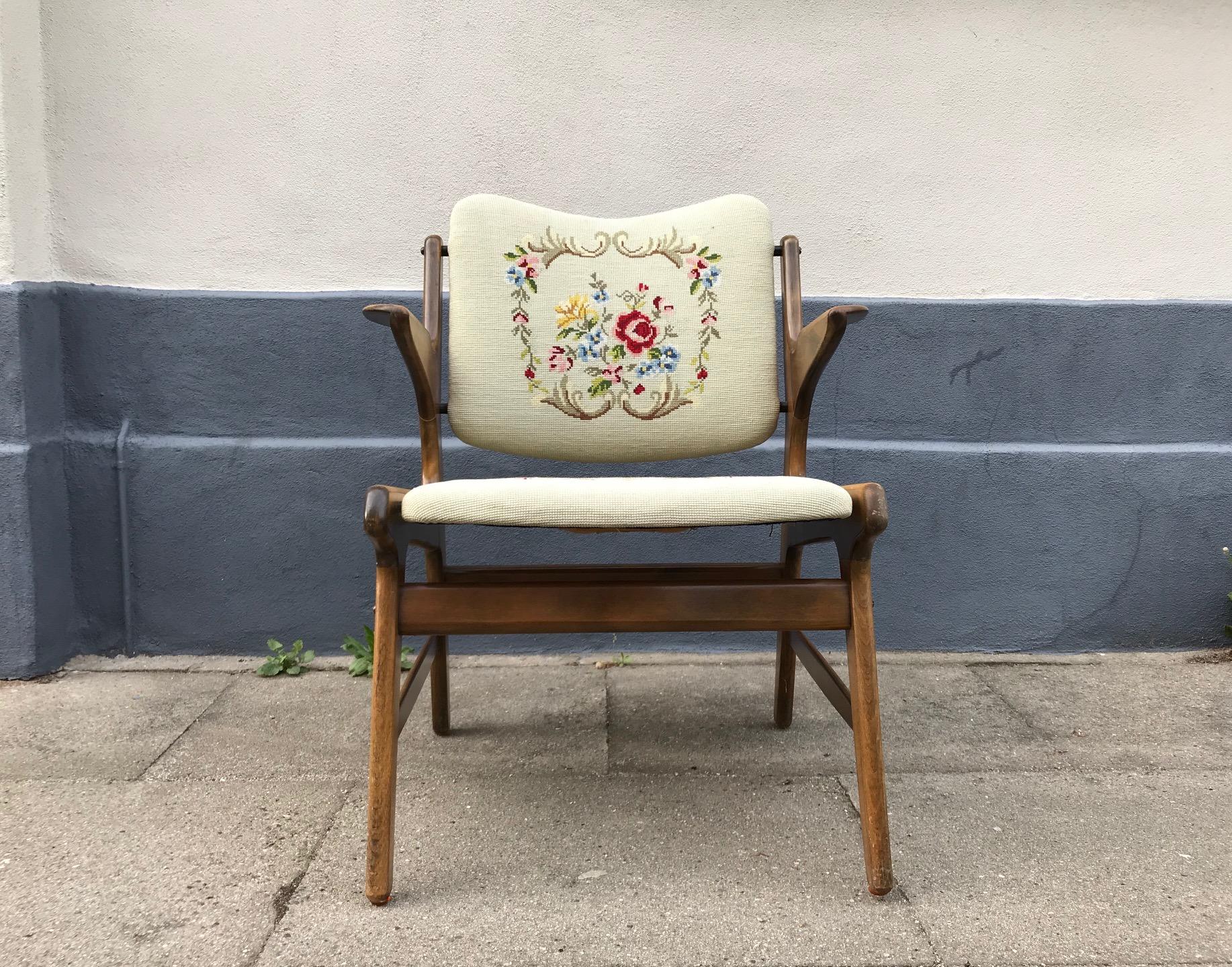 Small easy chair fashioned of stained oak. Upholstery in hand embroidered wool. It was designed by A. Hovmand Olsen in the early 1950s and manufactured by A.R. Klingeberg & Søn in Denmark. It is easily upholstered if the current fabric is