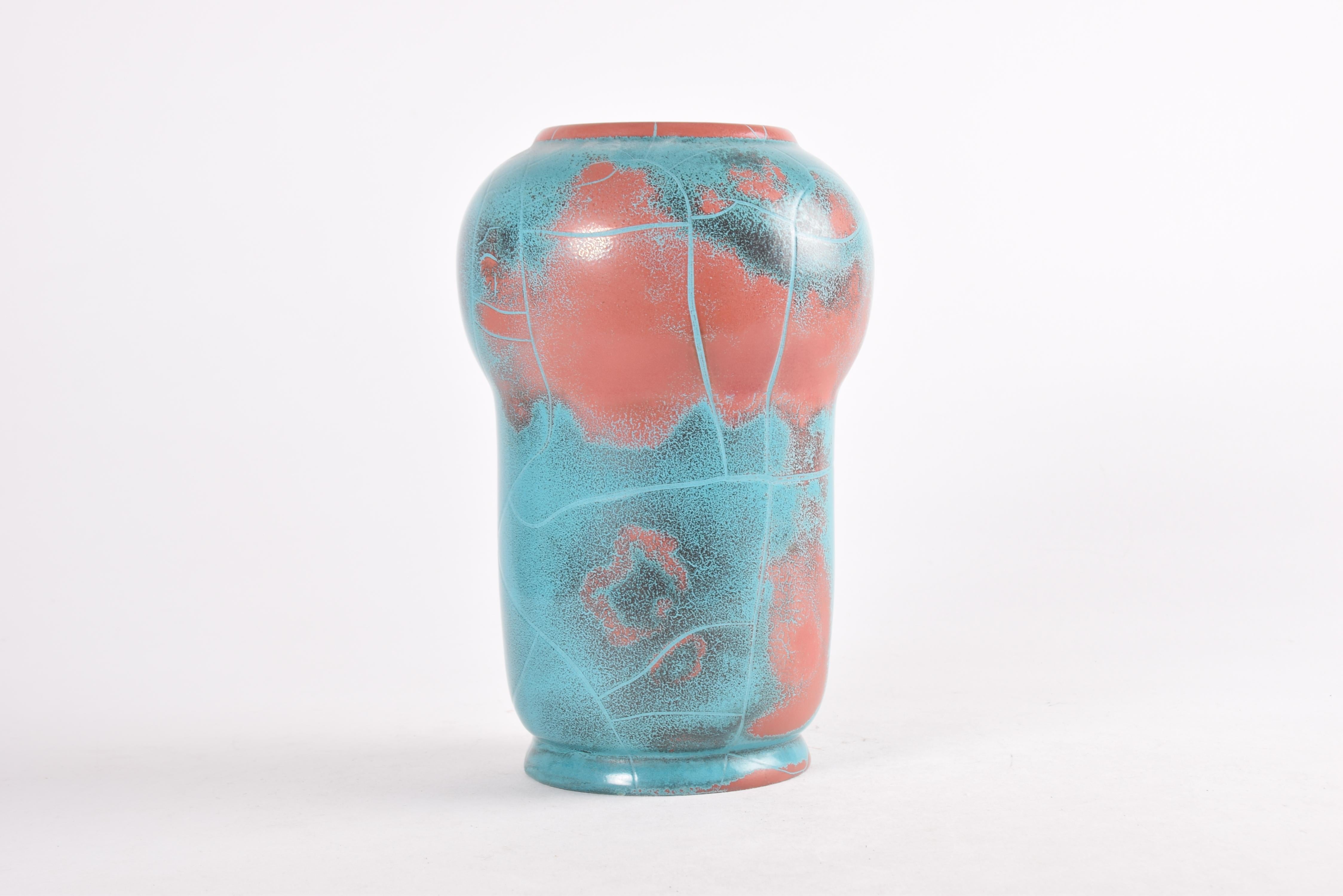 Rare tall vase from the Danish ceramic manufacturer P. Ibsens Enke, which was situated in Copenhagen. Made ca. 1930s.

The glaze is turquoise and red and shows a crackle effect. It was developed for P. Ipsens Enke by the ceramist Axel Sørensen
