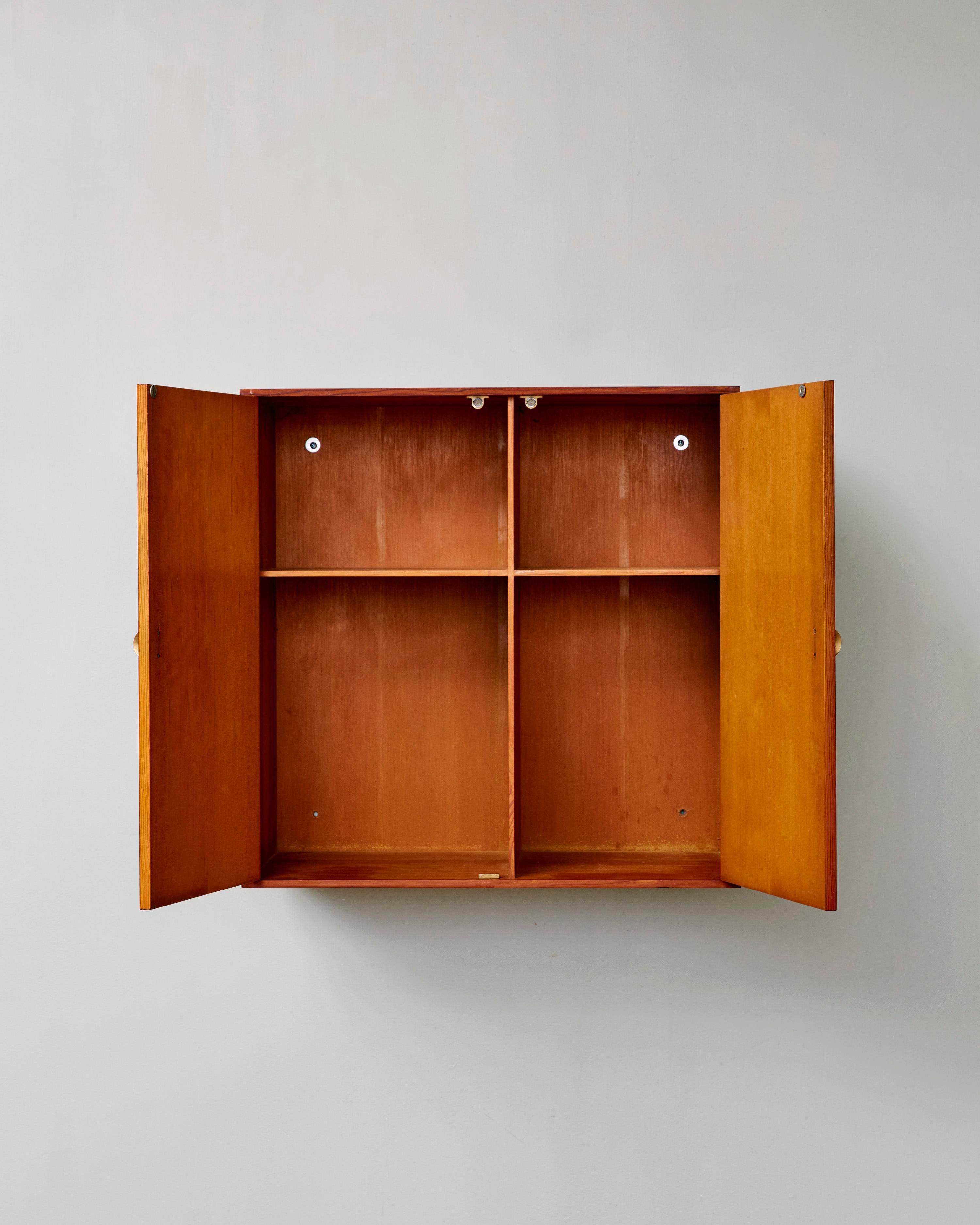 Rare Danish Floating Pine Cabinet with brass handles and double-sided shelving.

