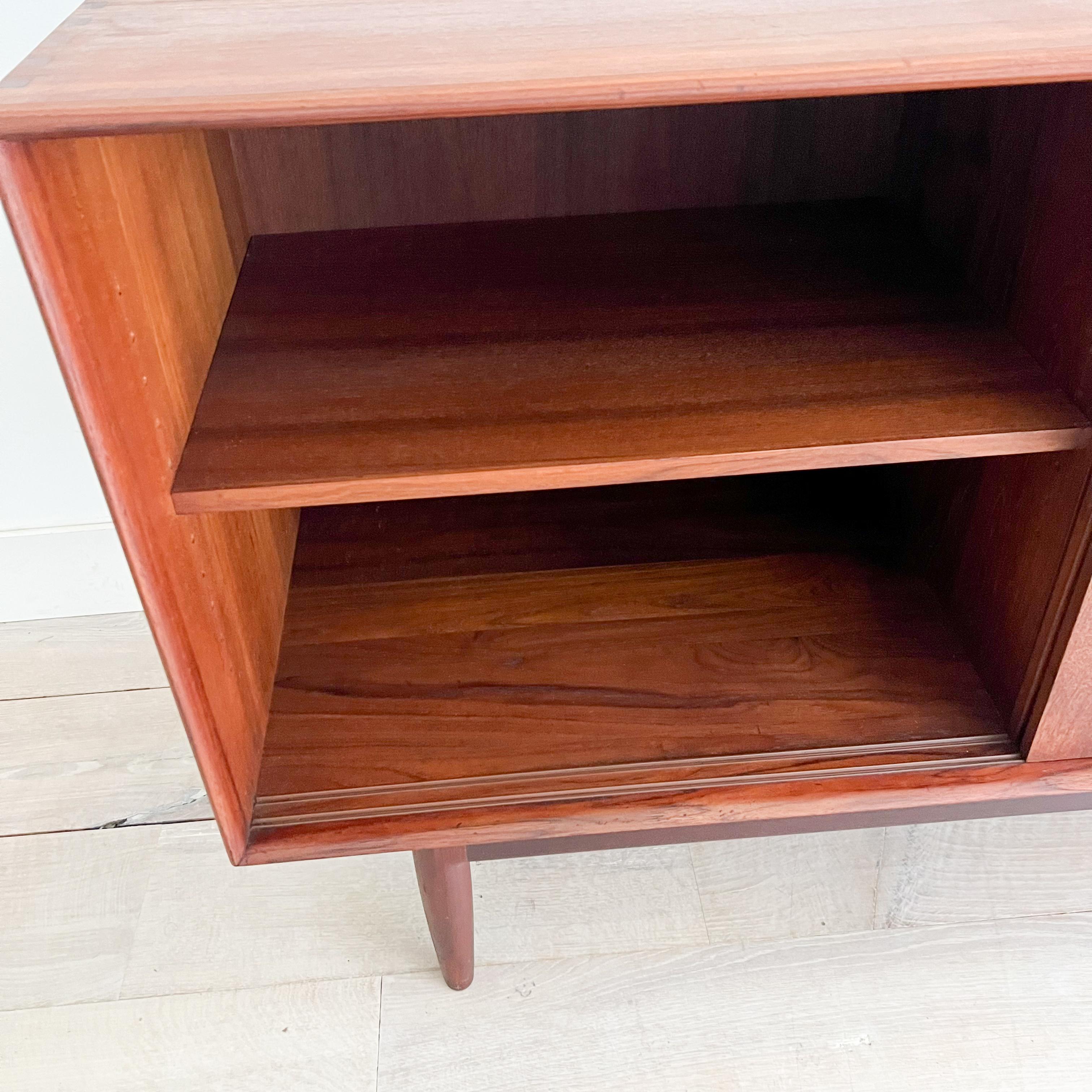 Discover a truly unique addition to your home with this exquisite mid-century modern solid teak credenza, designed by the renowned Johannes Aasbjerg. Measuring 71.75” x 19.75” x 32”H, this stunning piece showcases the timeless elegance and superior