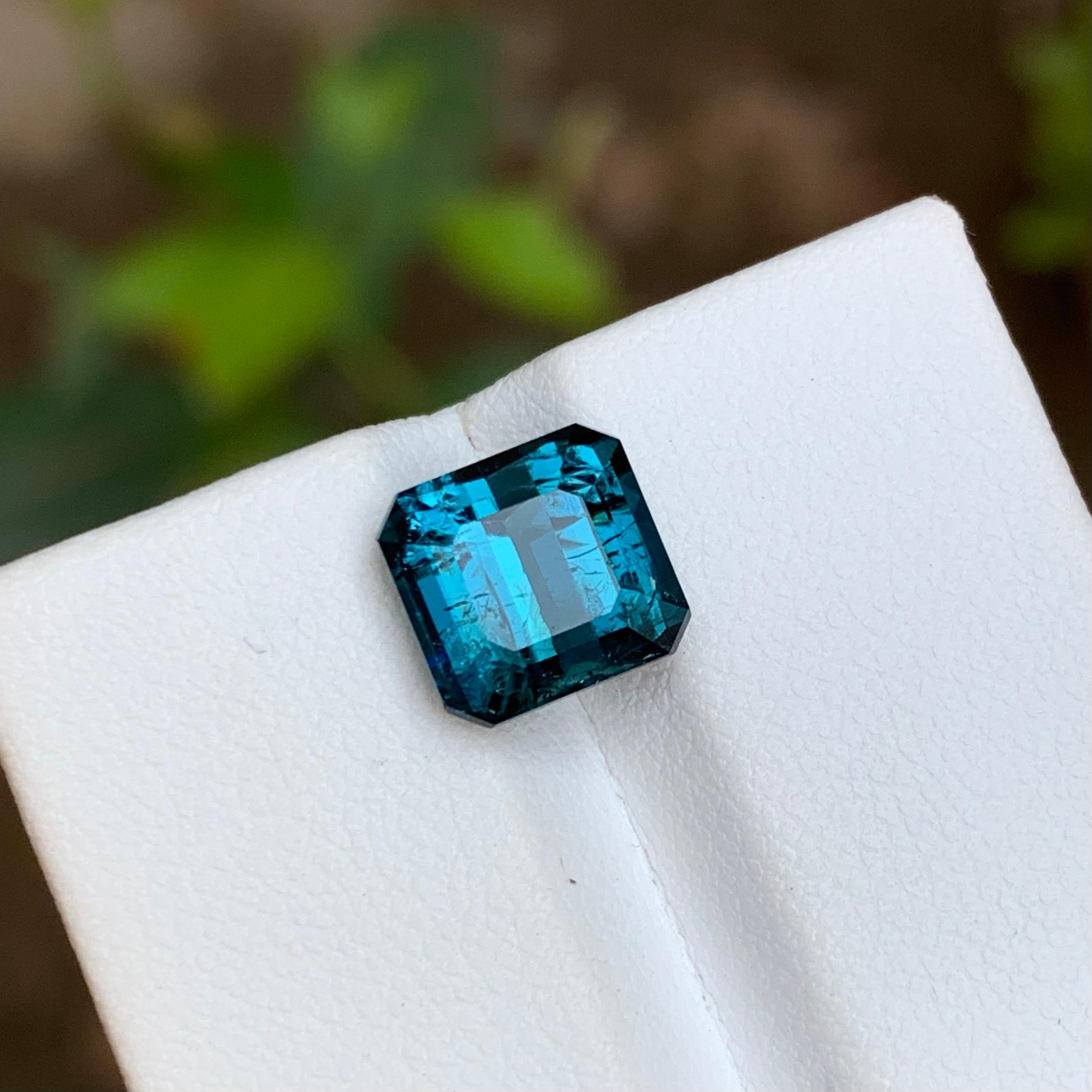 GEMSTONE TYPE: Tourmaline
PIECE(S): 1
WEIGHT: 3.70 Carats
SHAPE: Square Emerald 
SIZE (MM): 8.14 x 8.57 x 6.38
COLOR: Darkish Blue
CLARITY: Moderately Included 
TREATMENT: None
ORIGIN: Afghanistan
CERTIFICATE: On demand
(if you require a