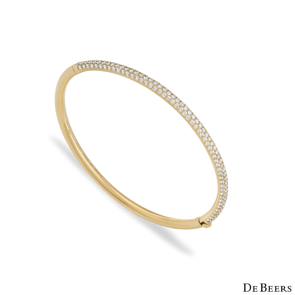 An elegant 18k yellow gold diamond bangle by De Beers from the Classics collection. The bangle features 162 micropave set round brilliant cut diamonds totalling 2.03ct, predominately F-G colour and VS+ clarity. The bangle fits a wrist up to 16cm,