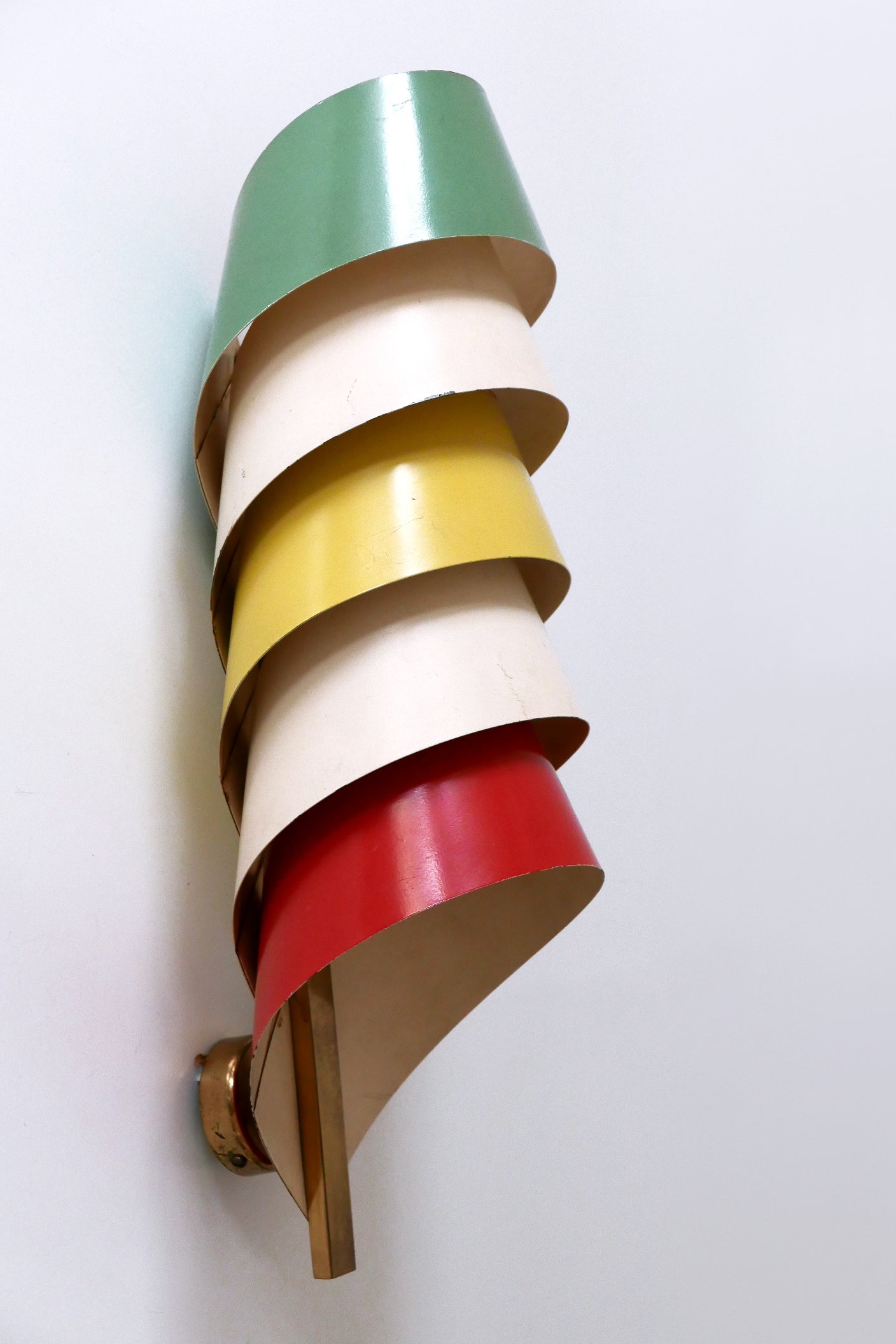 Extremely rare, elegant and highly decorative Mid-Century Modern sconce or wall fixture. Designed and manufactured probably in Scandinavia, 1950s.

Executed in brass and multi colored metal, the sconce comes with 1 x E27 / E26 Edison screw fit bulb