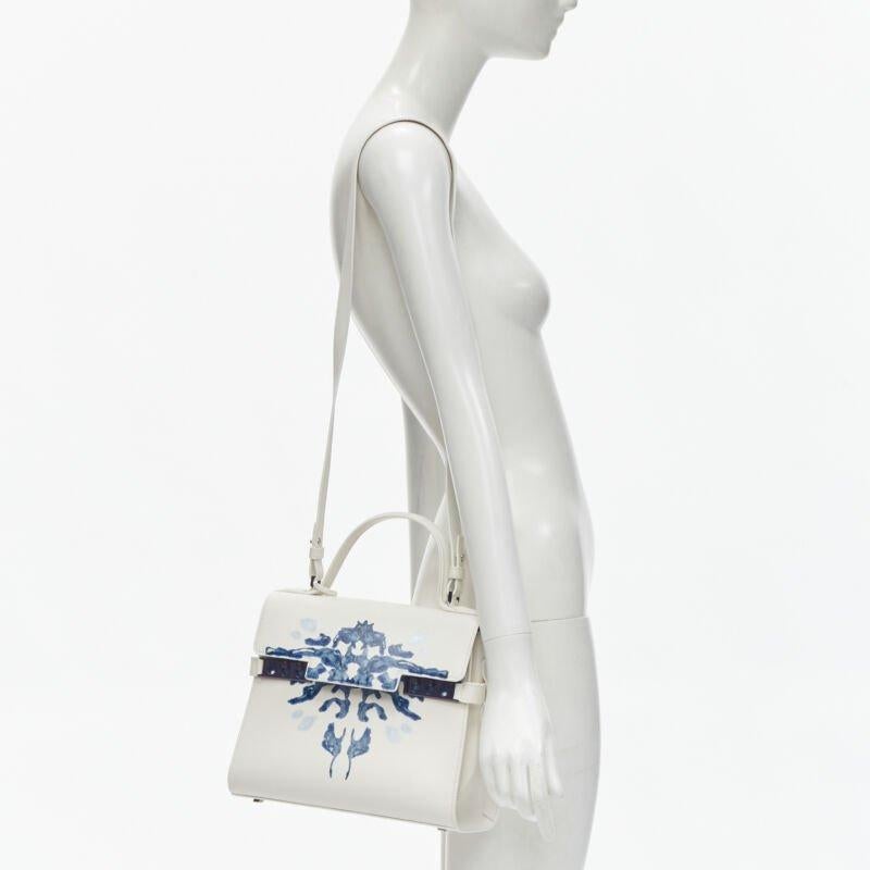 rare DELVAUX 2017 Limited Edition Tempete MM B Papillon lambskin leather bag
Reference: KNLM/A00239
Brand: Delvaux
Model: Tempete MM Papillon
Material: Calfskin Leather
Color: White, Blue
Pattern: Abstract
Closure: Push Lock
Lining:  Leather
Extra